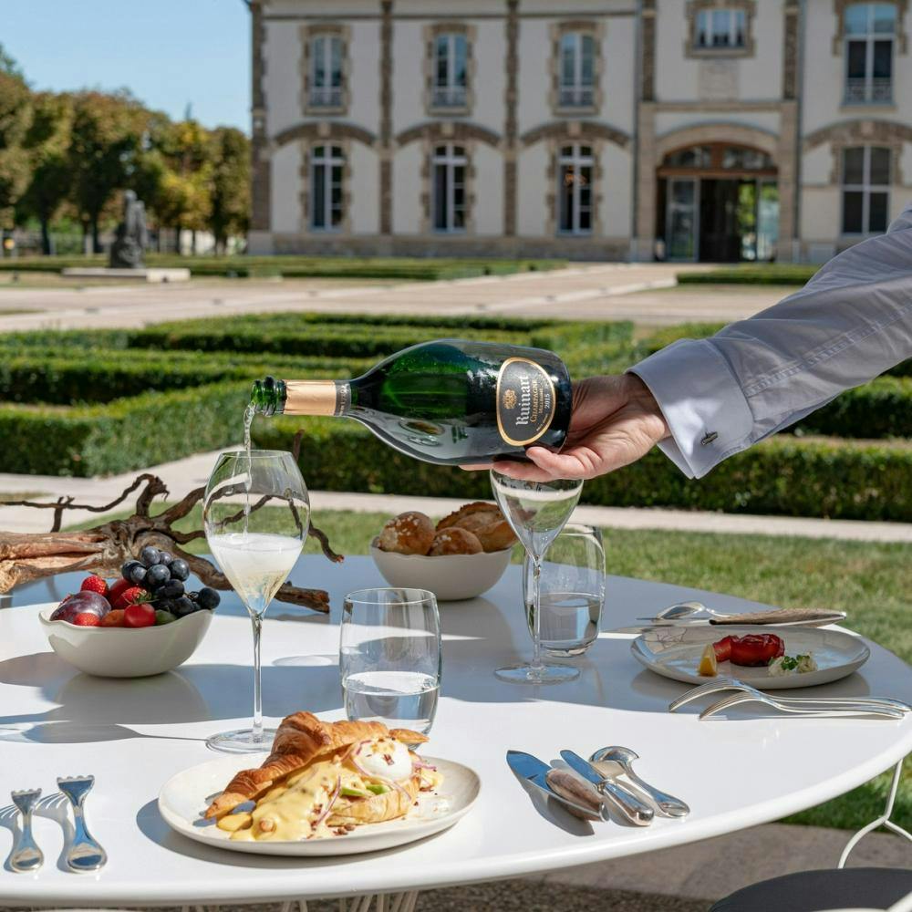 Lunch is served with champagne in the courtyard of house of Ruinart.