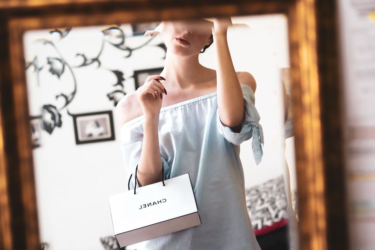 Woman holding a Chanel gift bag