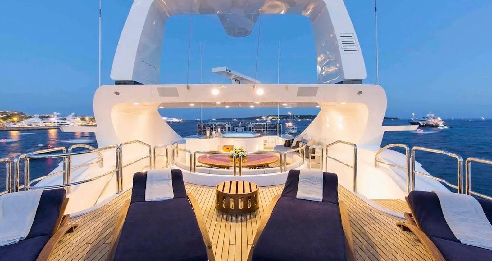 Sun deck with sun loungers and jacuzzi onboard a luxurious motor yacht.