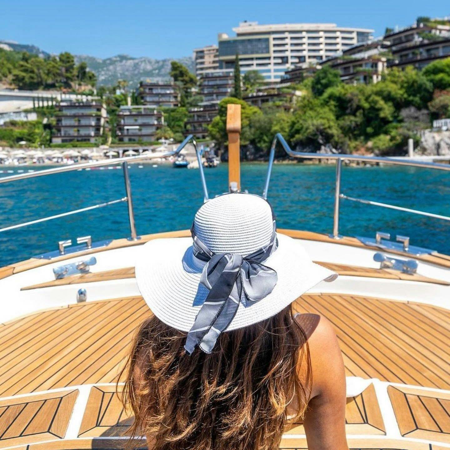 Beautiful woman on sailboat near French Riviera coast