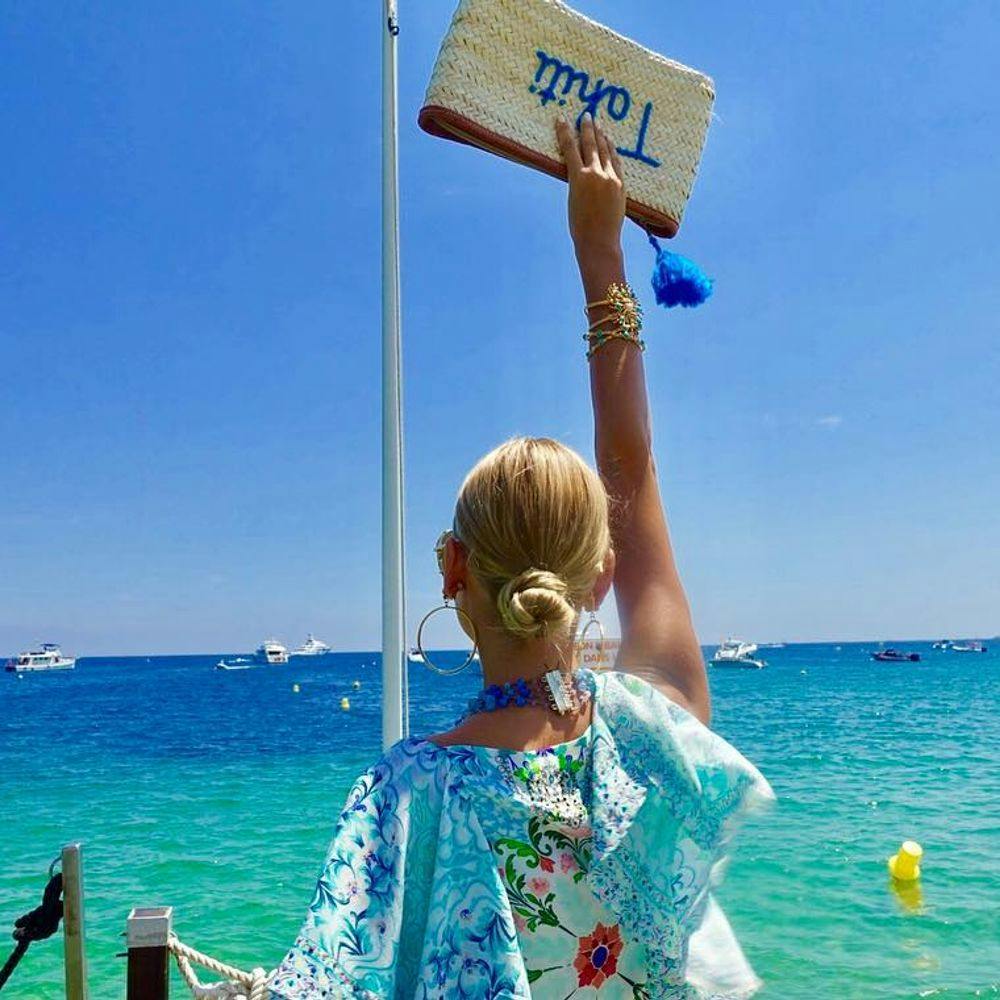 Woman standing on a quay in Saint-Tropez beach club Tahiti Beach