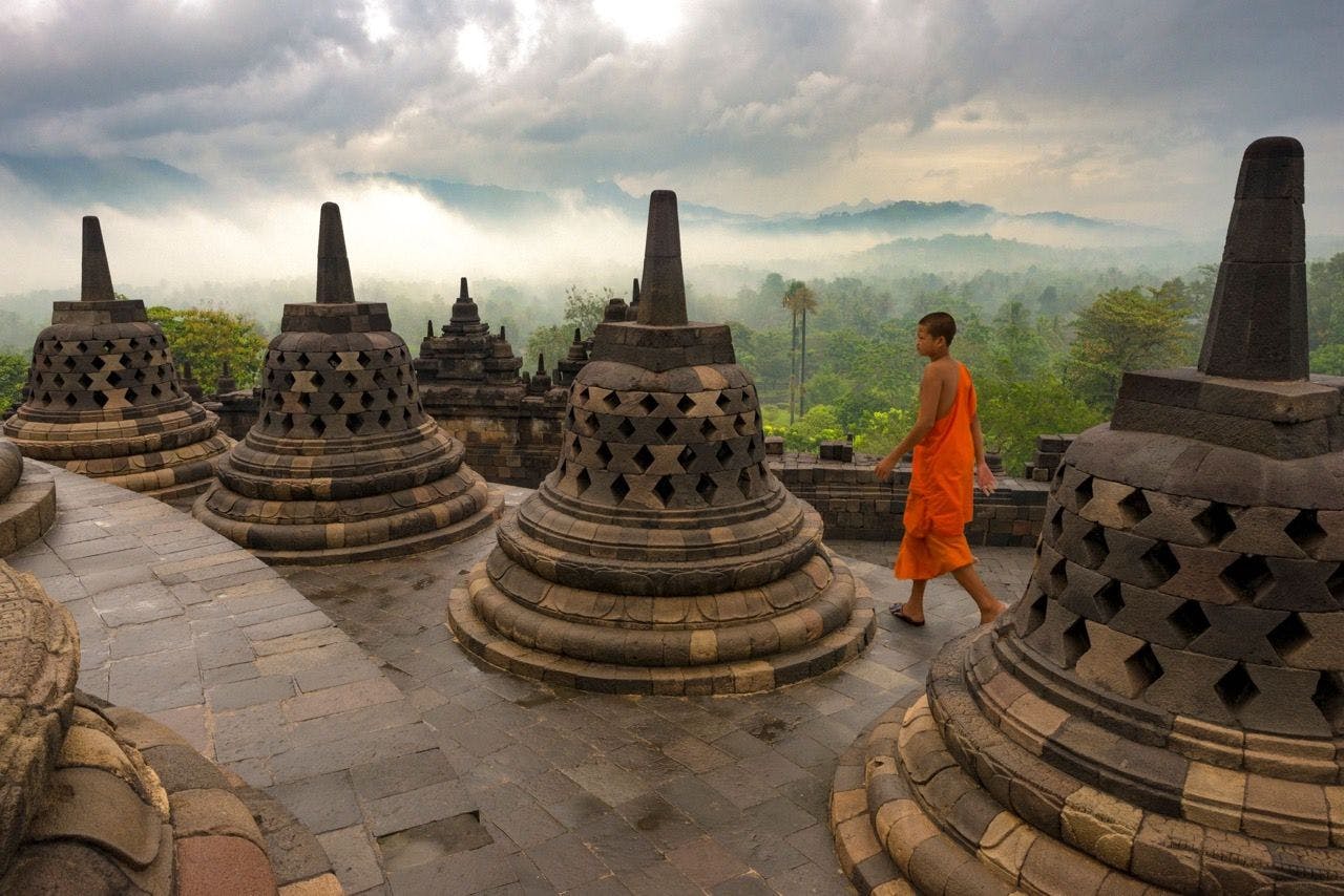 Buddhist monk walking in Borobudur in Java Indonesia.