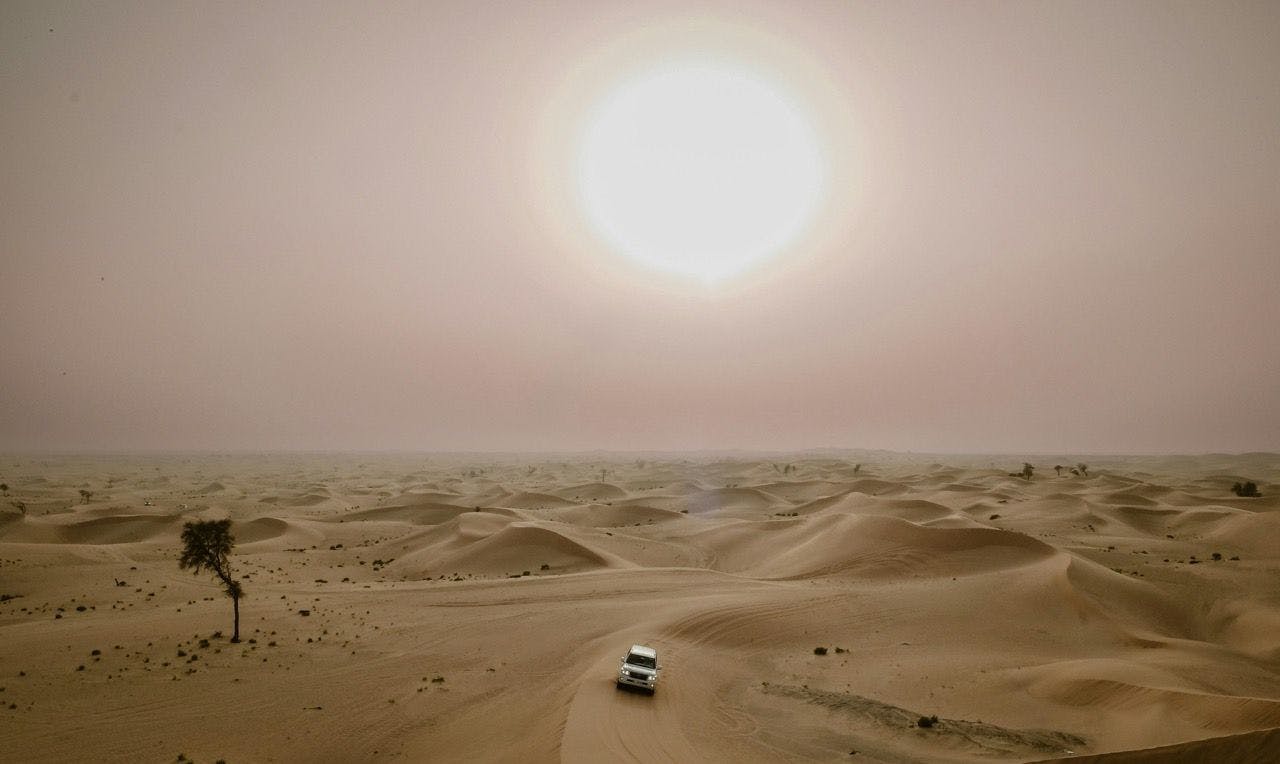 Jeep driving on the sand dunes in the Empty Quarter in UAE.