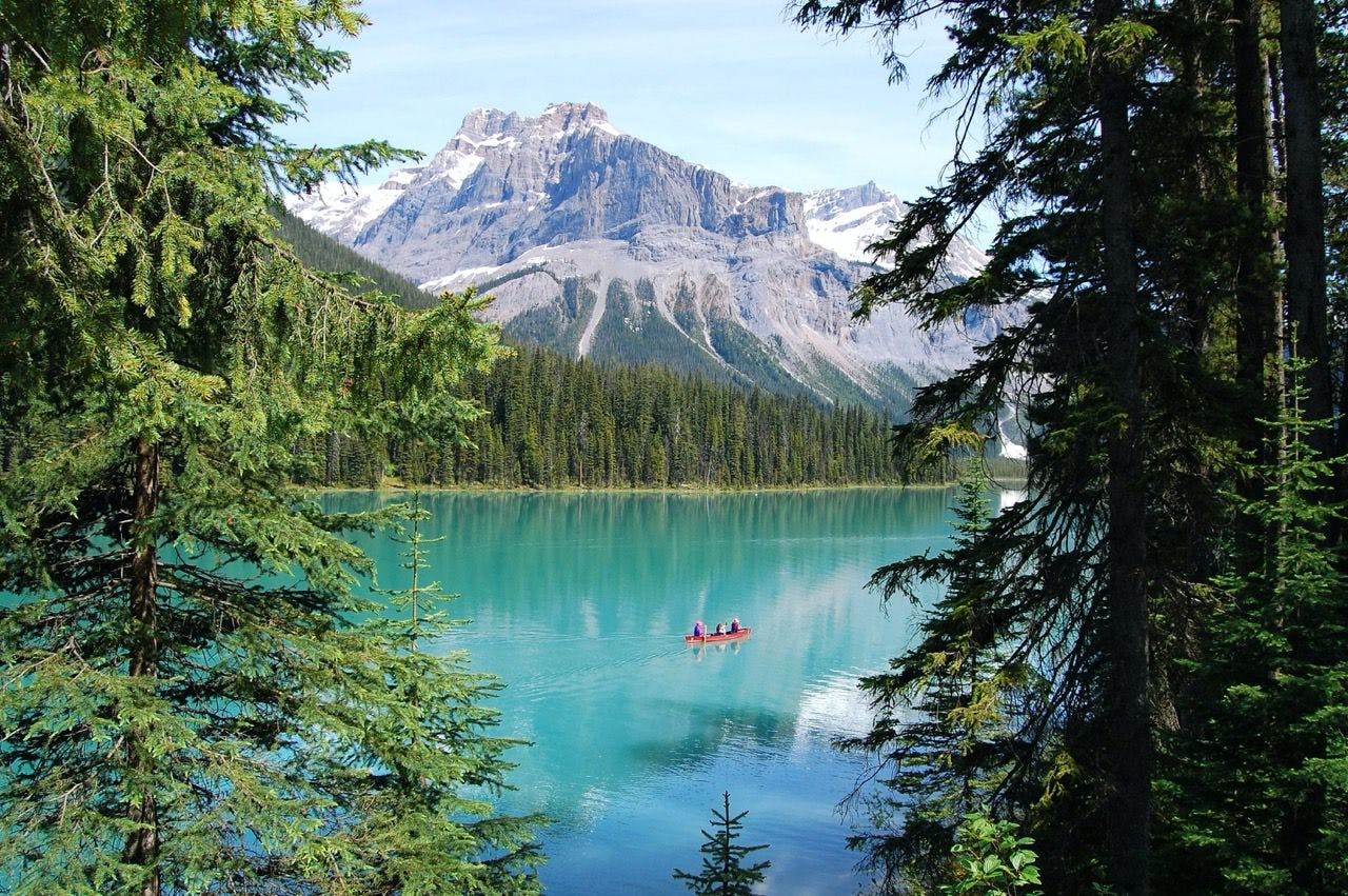 People canoeing on Emerald Lake in Canada.