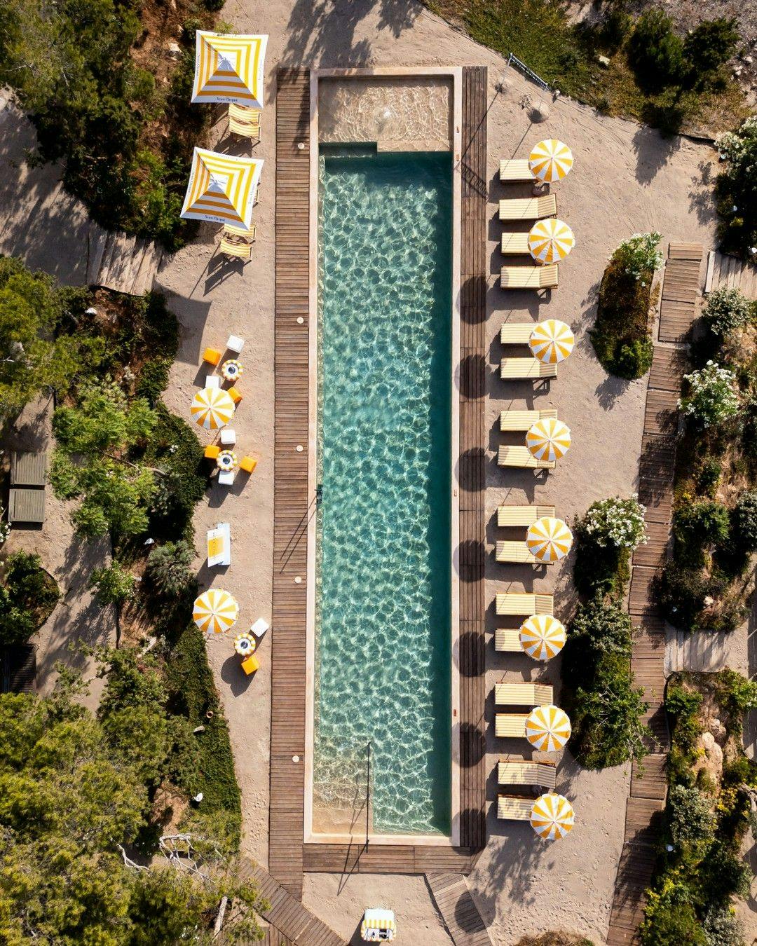 Swimming pool with sun loungers in Six Senses resort in Ibiza.