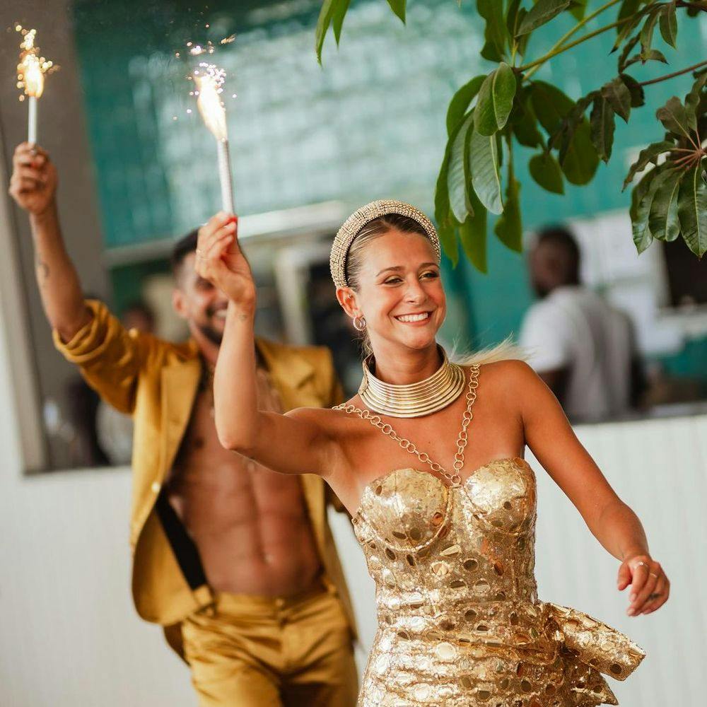 Woman in golden dress in Nikki Beach Marbella beach club in Costa Del Sol