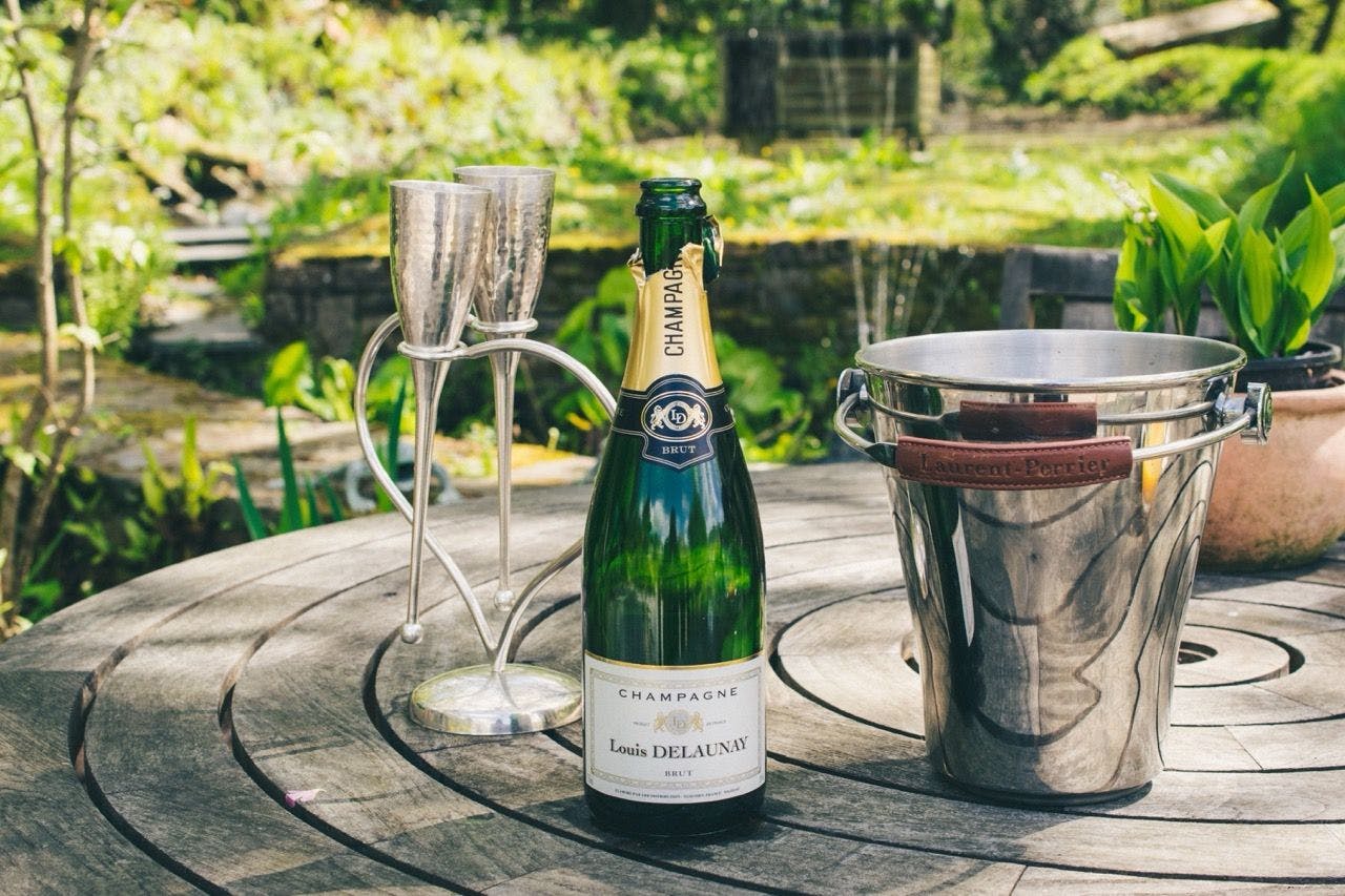 Champagne on a wooden table in the garden