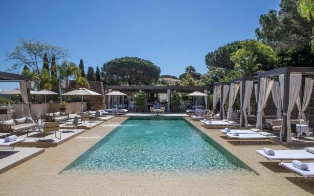 Swimming pool and sunbeds at MUSE Saint Tropez hotel.