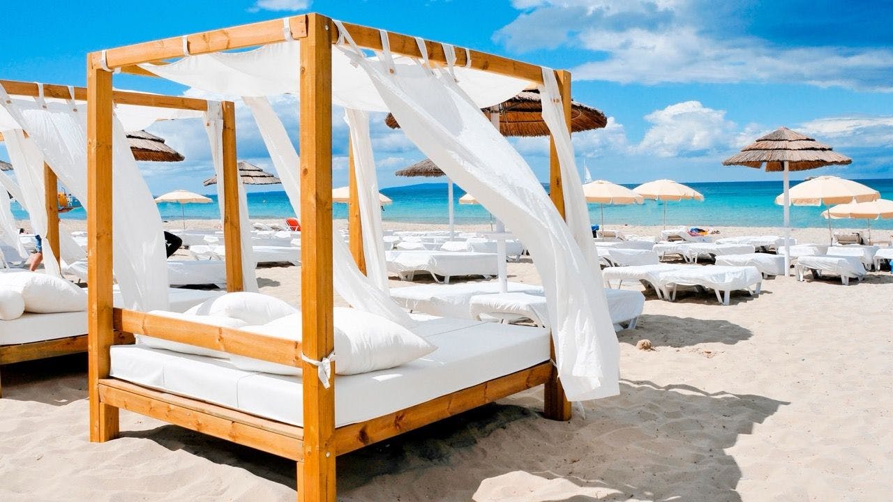 White sunbeds on the beach in Saint Tropez beach club in France