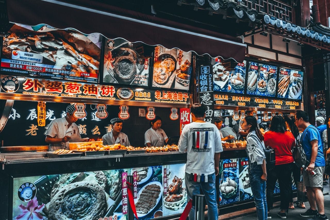 People buying street food in Shanghai, China.