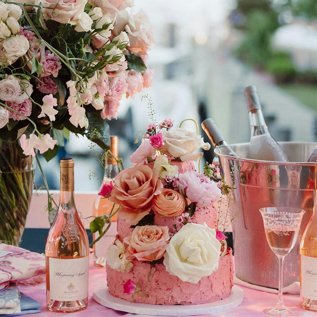 Bottles of sparkling wine in a cooler with glasses