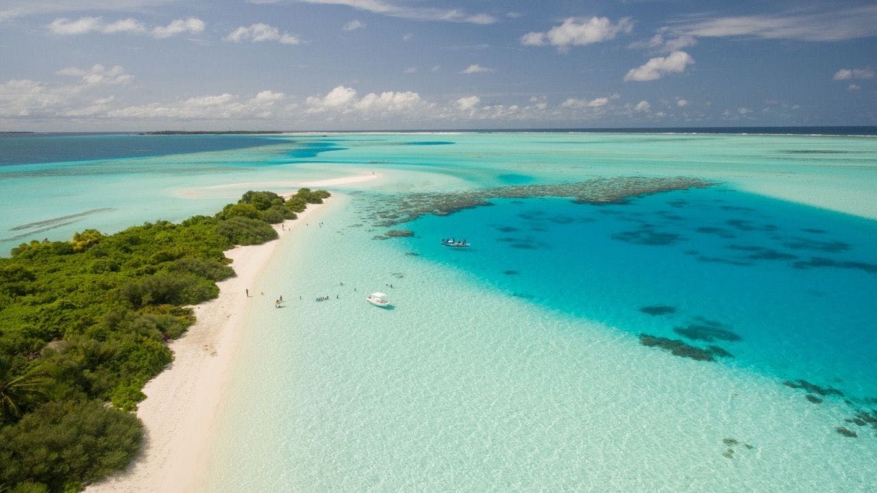 Maldives coastline with boat and pristine ocean