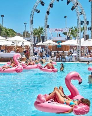 Floating flamingoes in swimming pool in Opium Beach Club Marbella