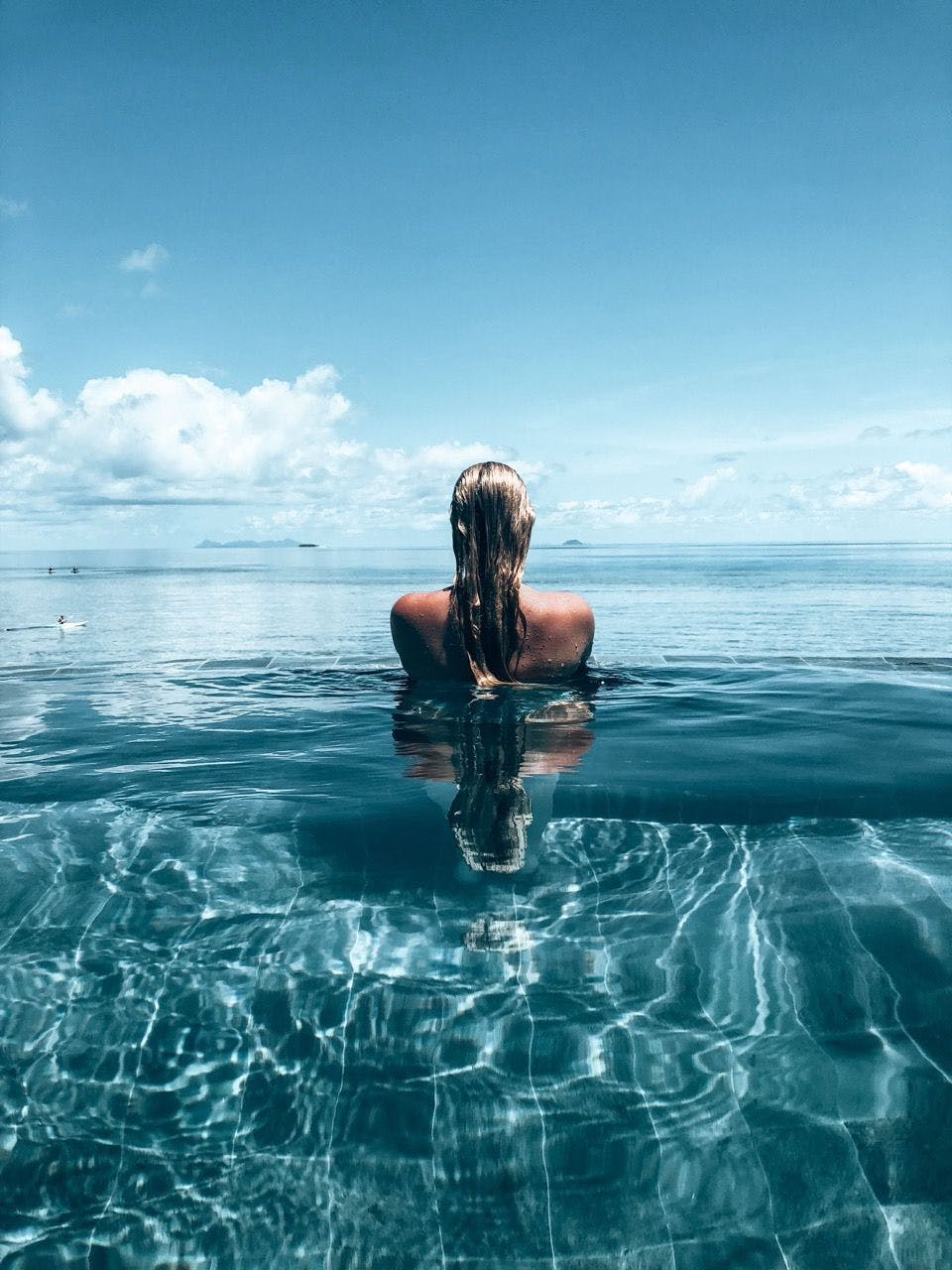 Woman standing in a swimming pool in Mykonos