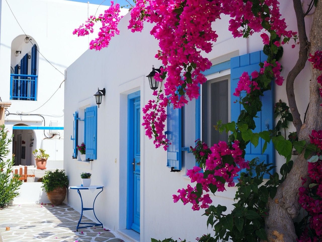 White house with blue doors and windows in Santorini Greece