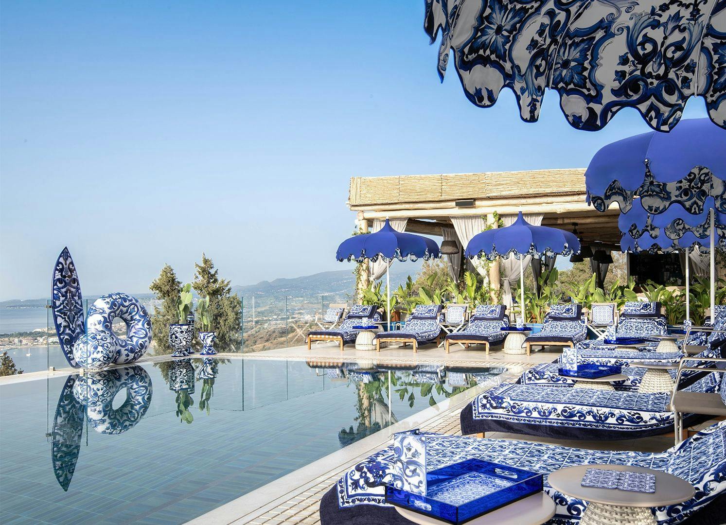 Infinity pool and Dolce & Gabbana branded sun loungers in San Domenico Palace resort.