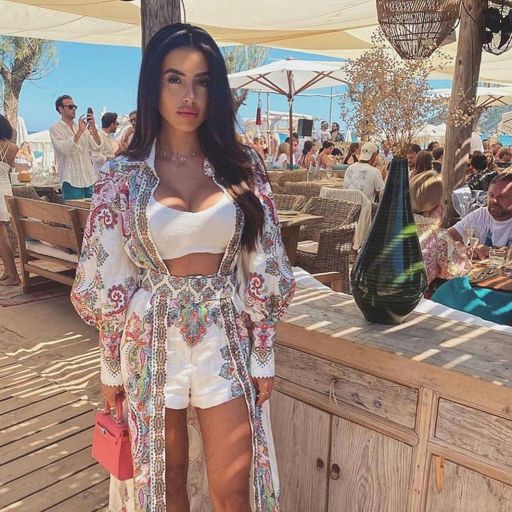 Woman standing in Saint-Tropez beach club Verde Beach