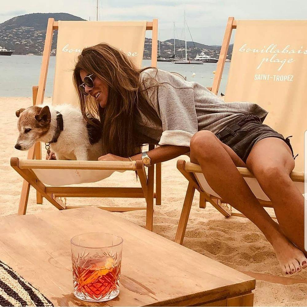 Woman with a dog at Saint-Tropez beach club La Bouillabaisse