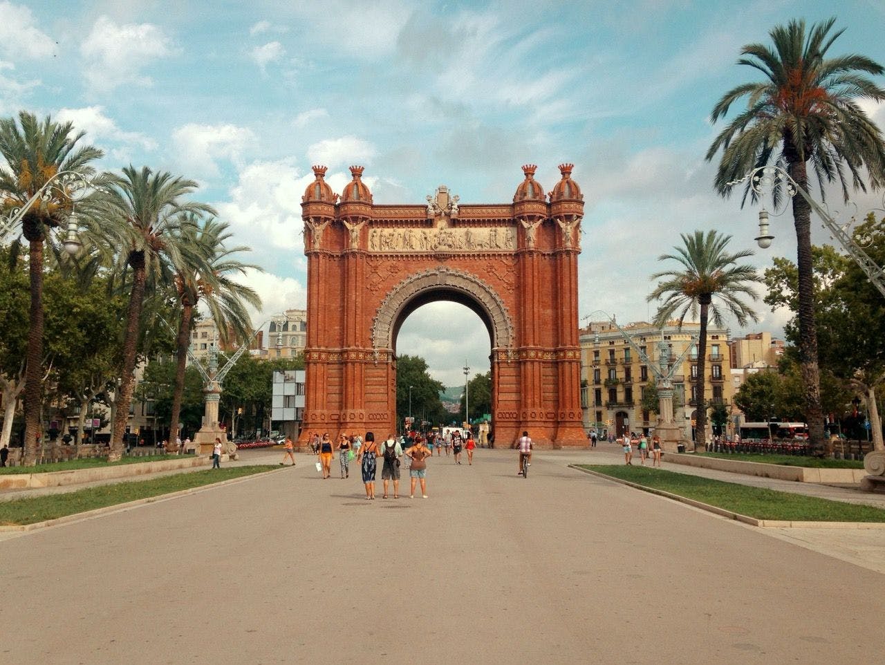 People walking under Arc de Triomf in Barcelona