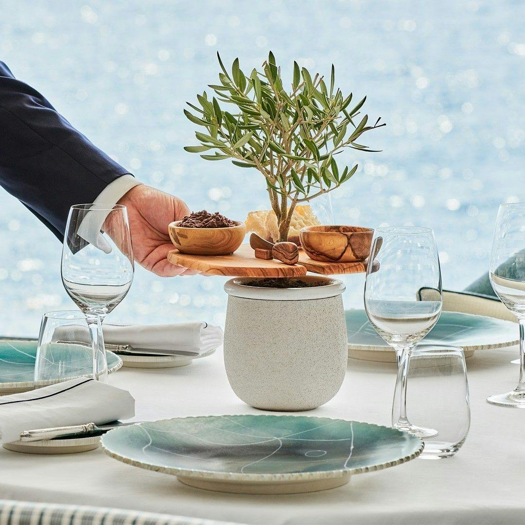 Decorated dinner table with tableware and string lights