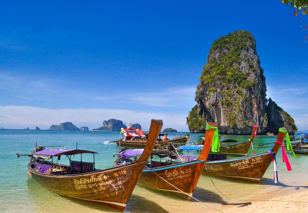 Boats on the coast of Phra Nang Beach in Krabi Thailand