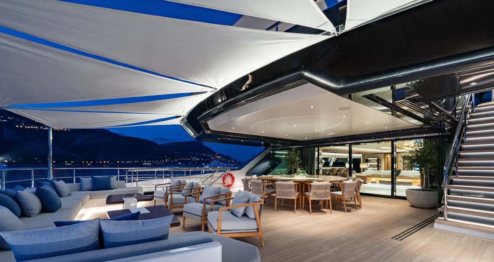 Extensive deck with lounge area on board of a superyacht.