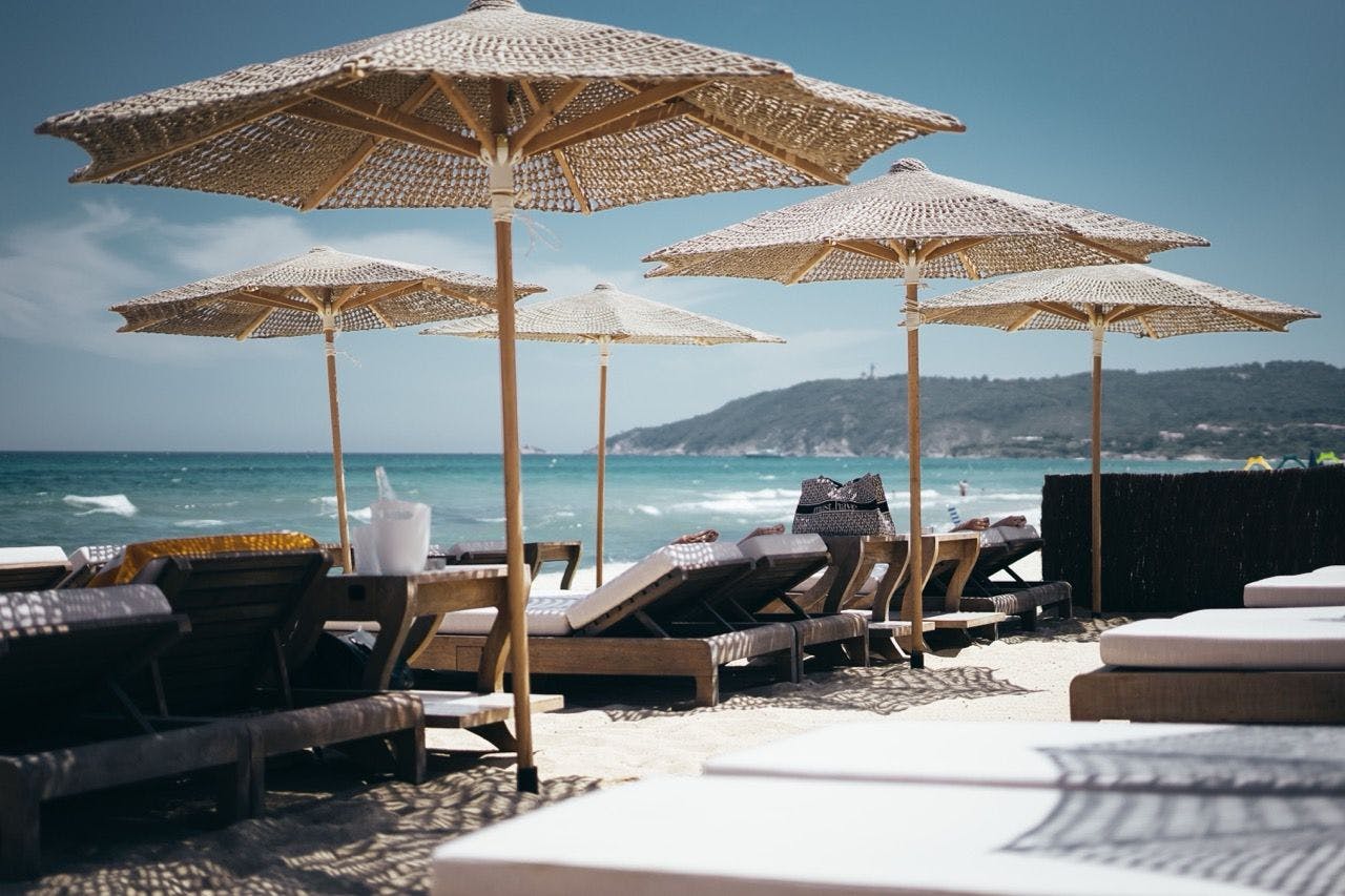 Saint-Tropez beach club scenery with sun loungers