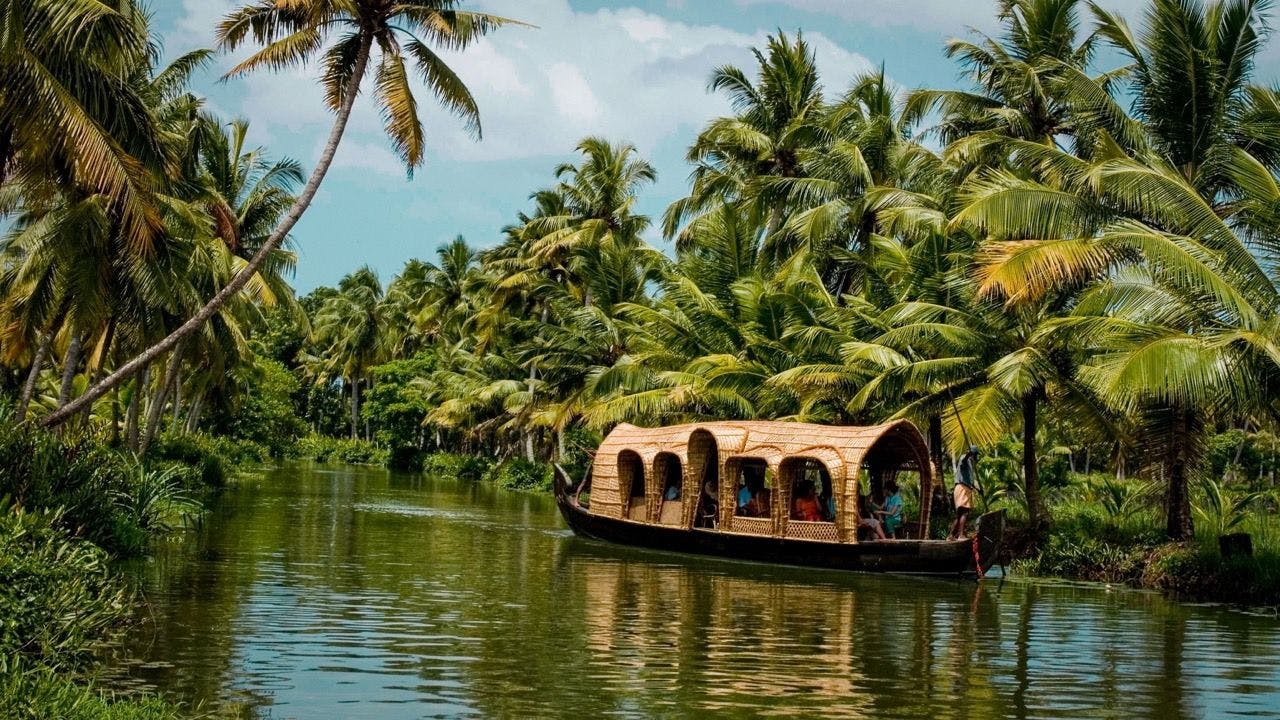 People sailing with river boat in Kerala India.