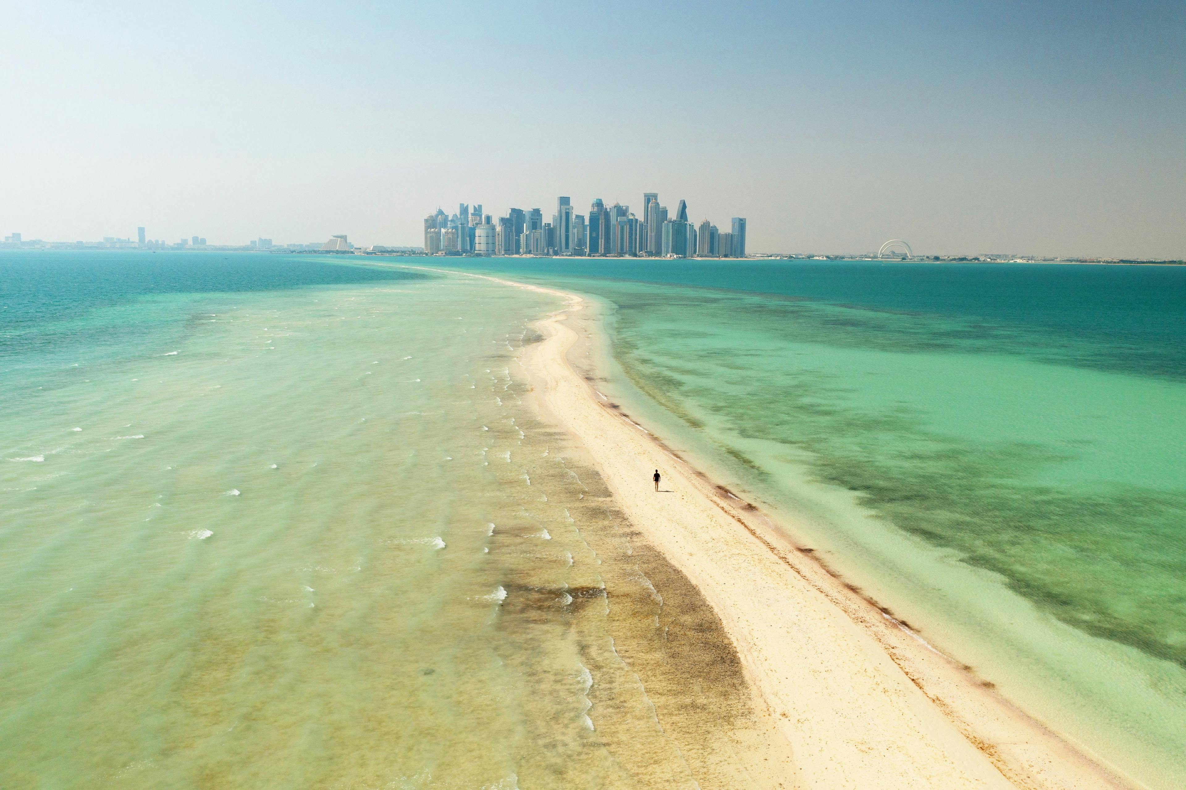 Man walking on Al Safliya Island in Qatar.