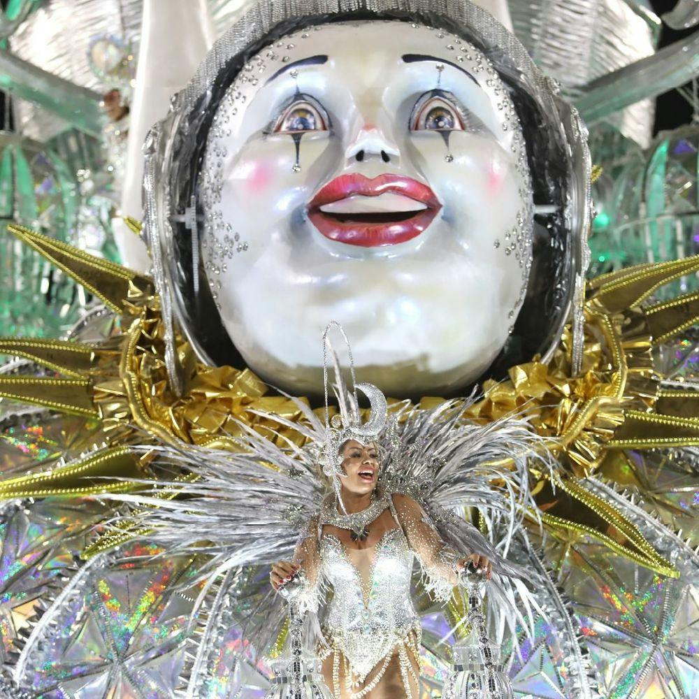 Woman wearing costume dancing with decorations in Rio Carnival.