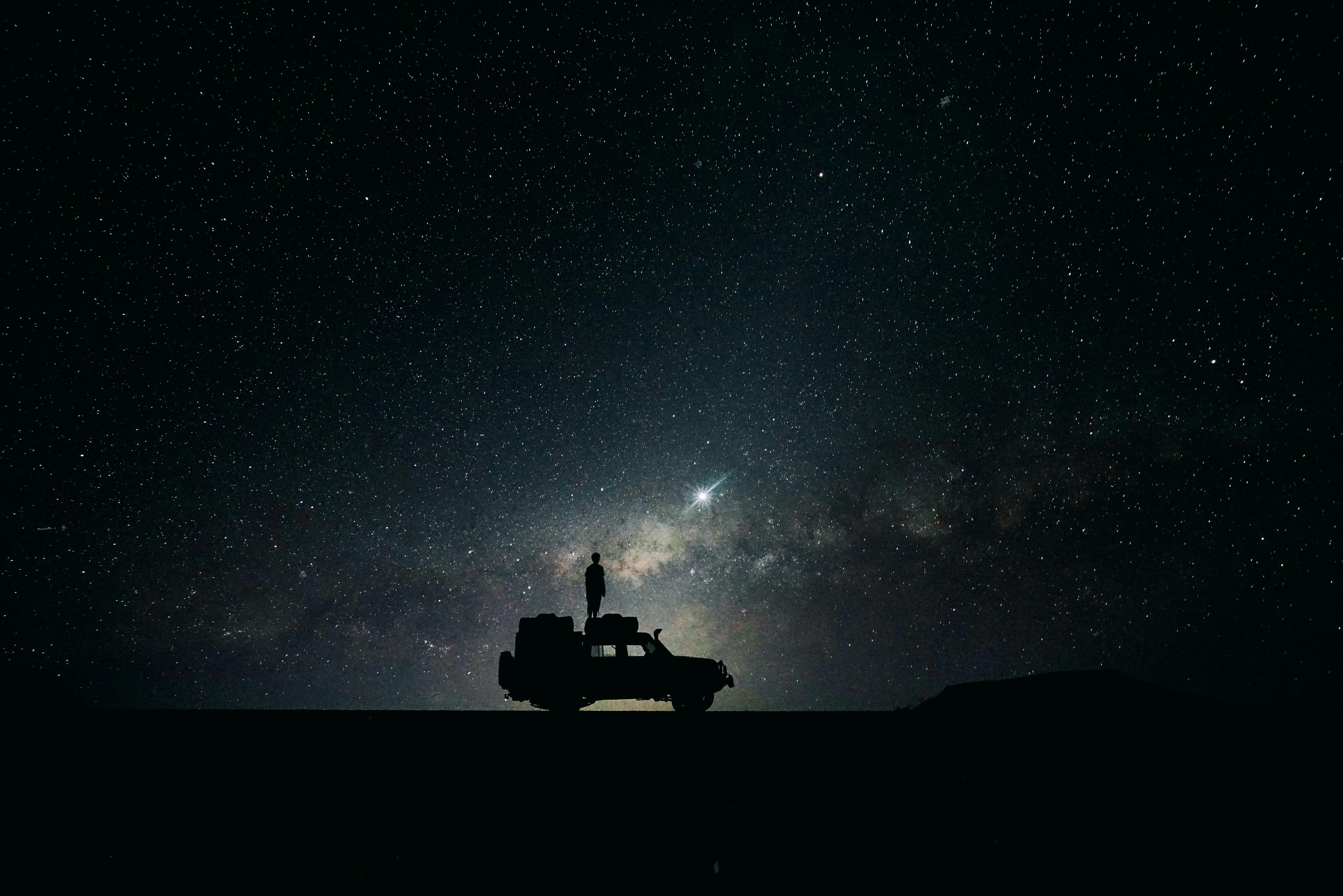 Man watching starry sky at Mesosaurus Camp in Namibia.