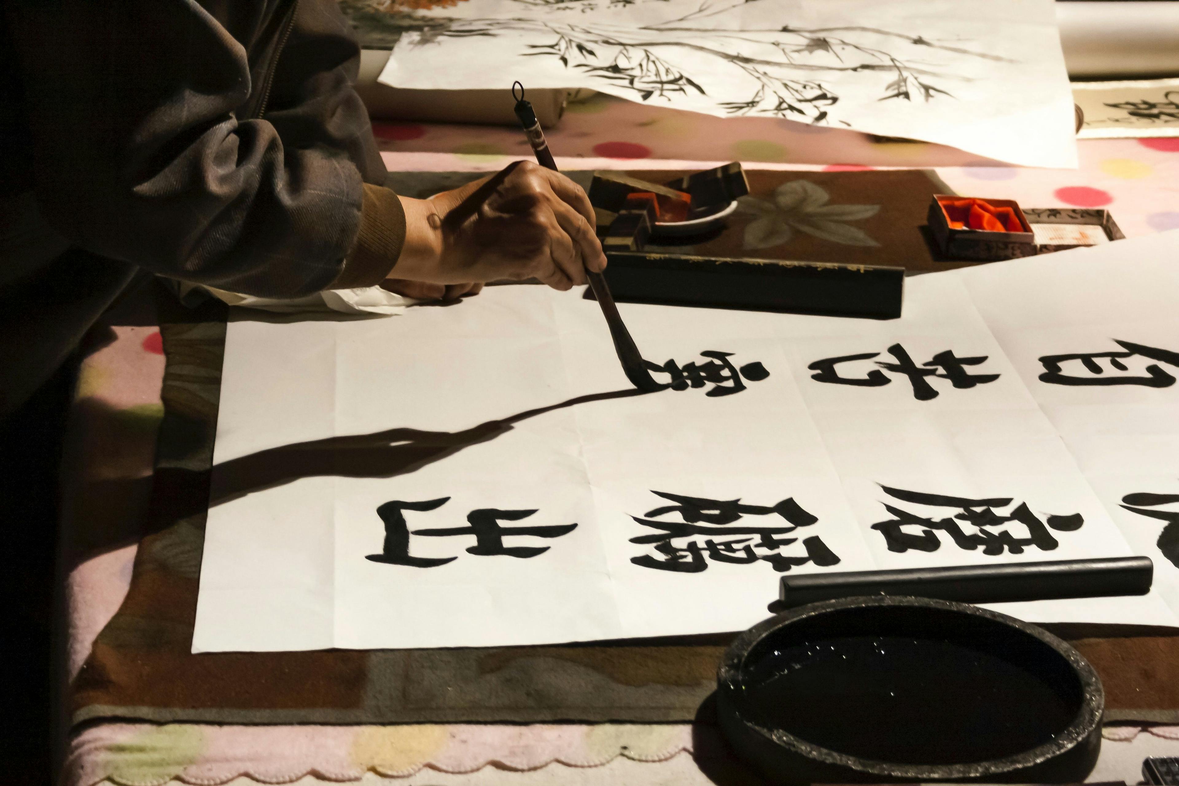 Man painting Chinese calligraphy in Beijing.