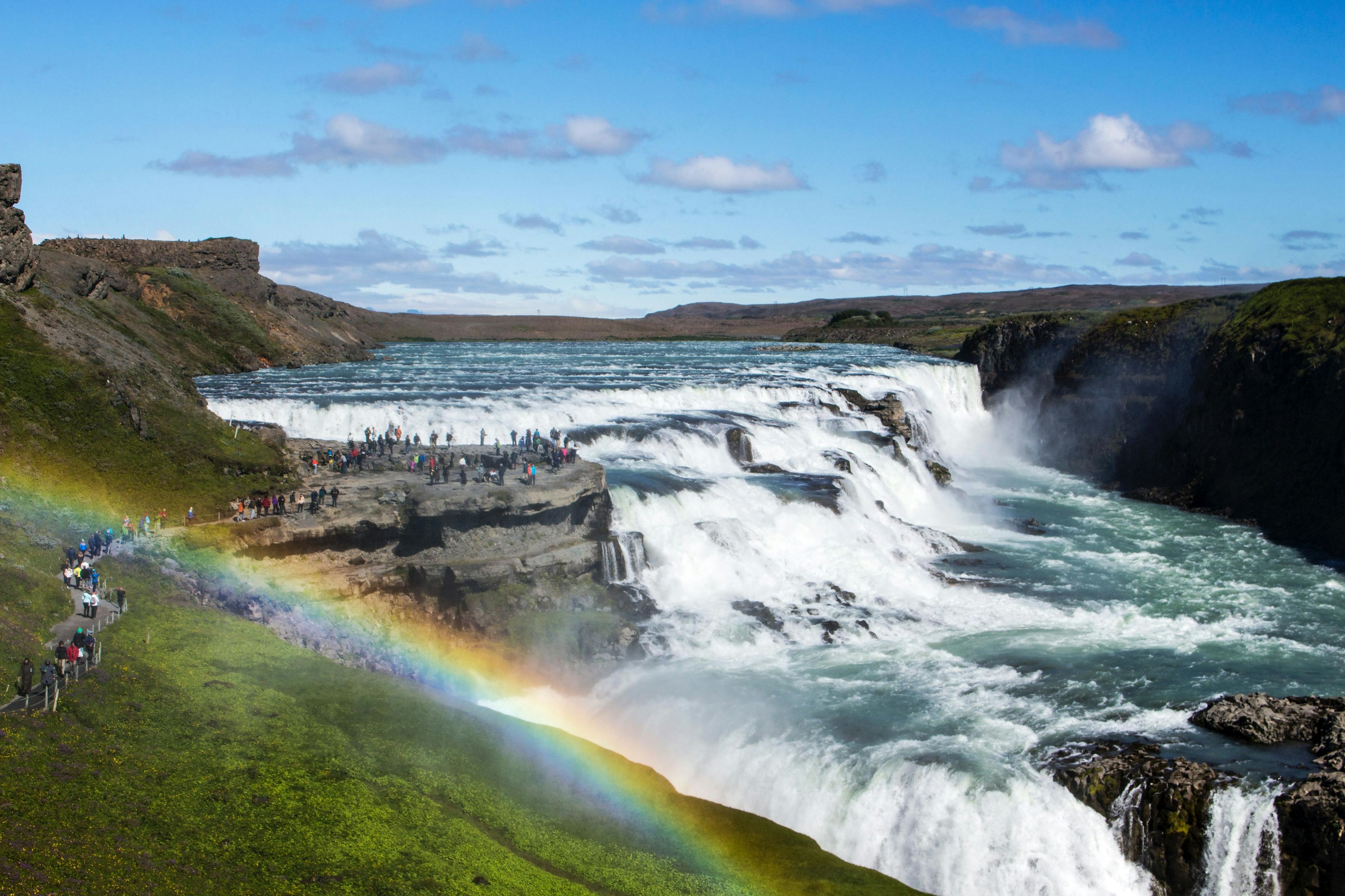 People observing Gullfoss waterfall in Iceland.