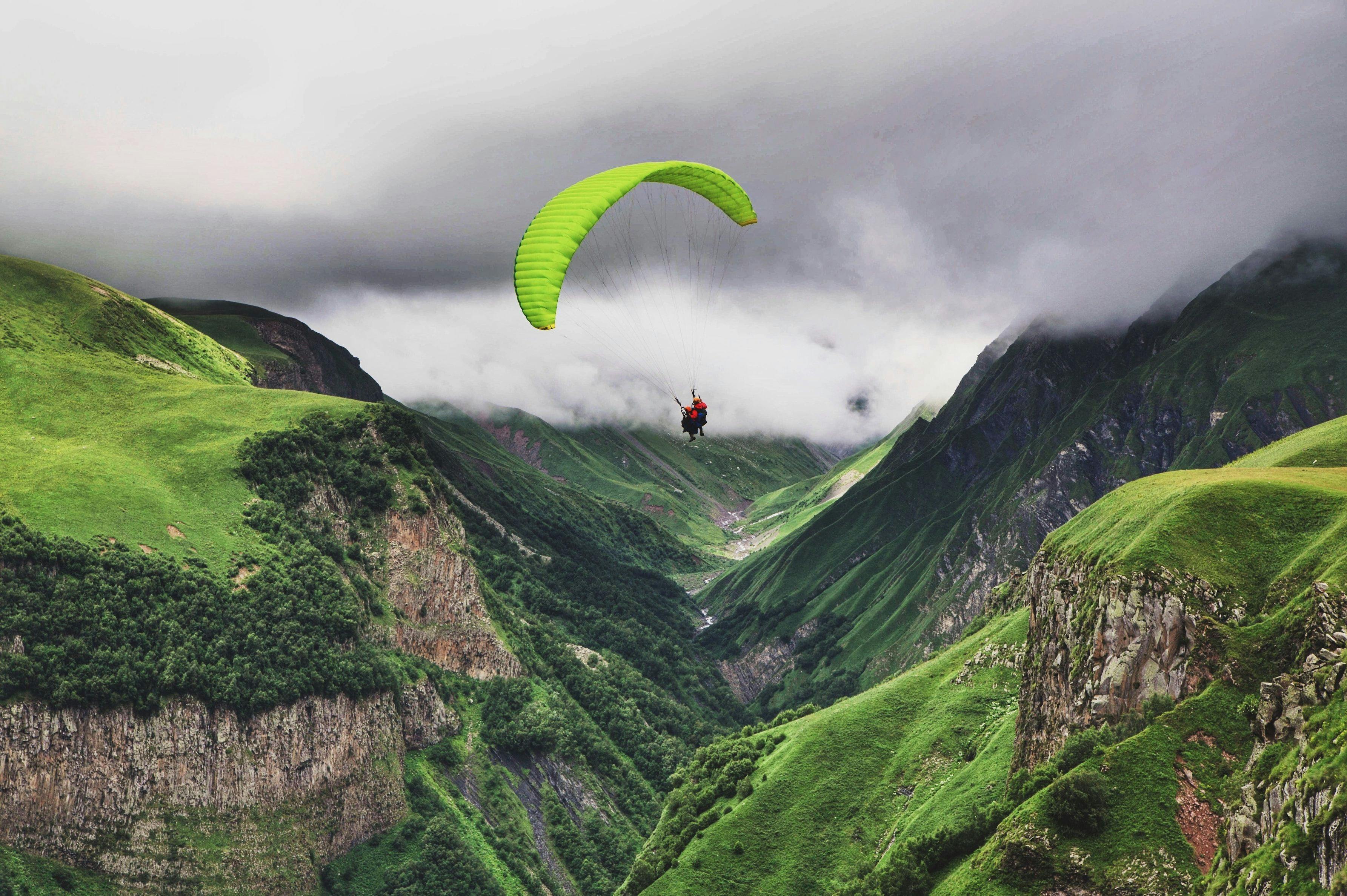 Flying a parachute in the mountains in Hail Al Shumaliyya, Seeb, Oman.