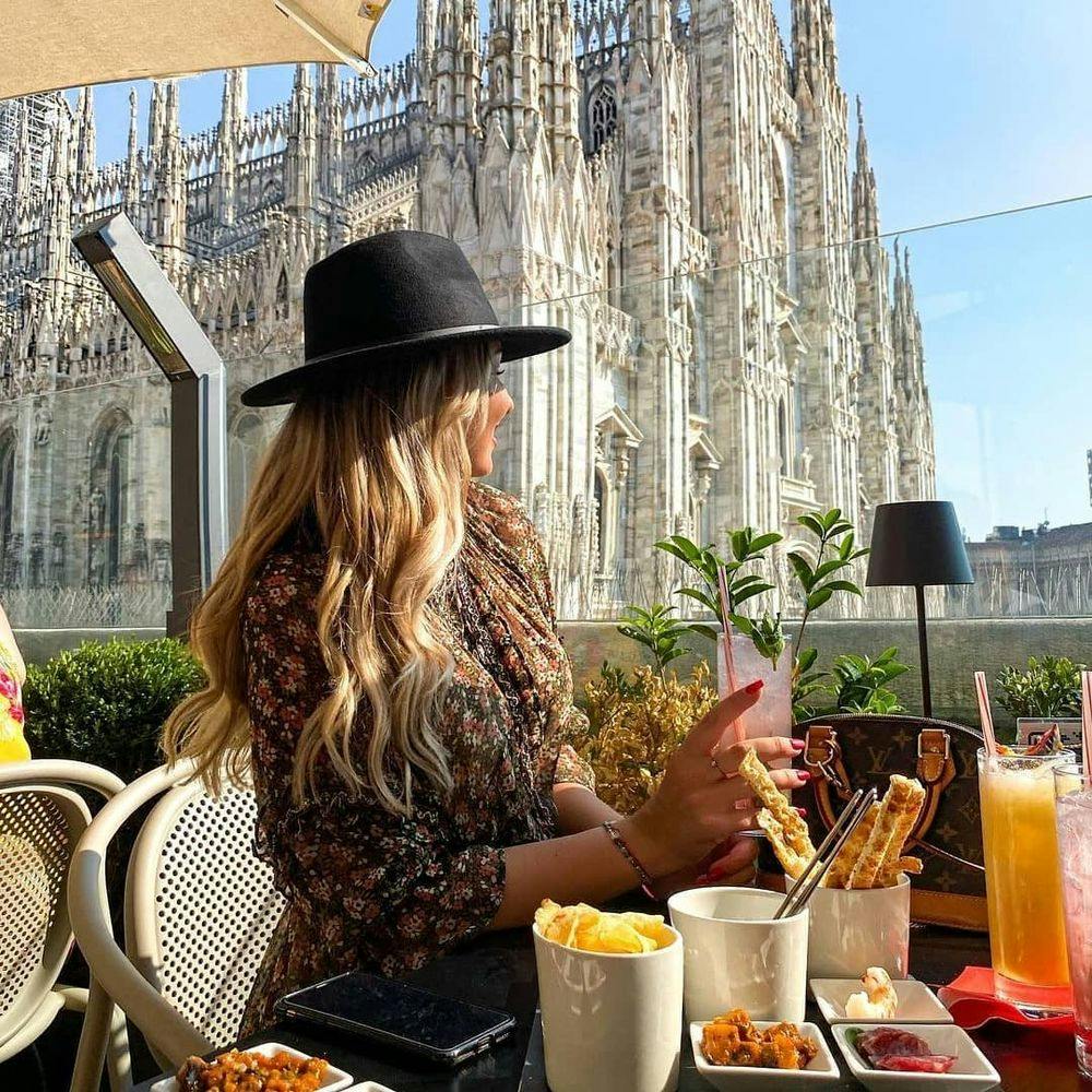 Woman enjoying aperitivo in Terazza Aperol rooftop bar in Milan