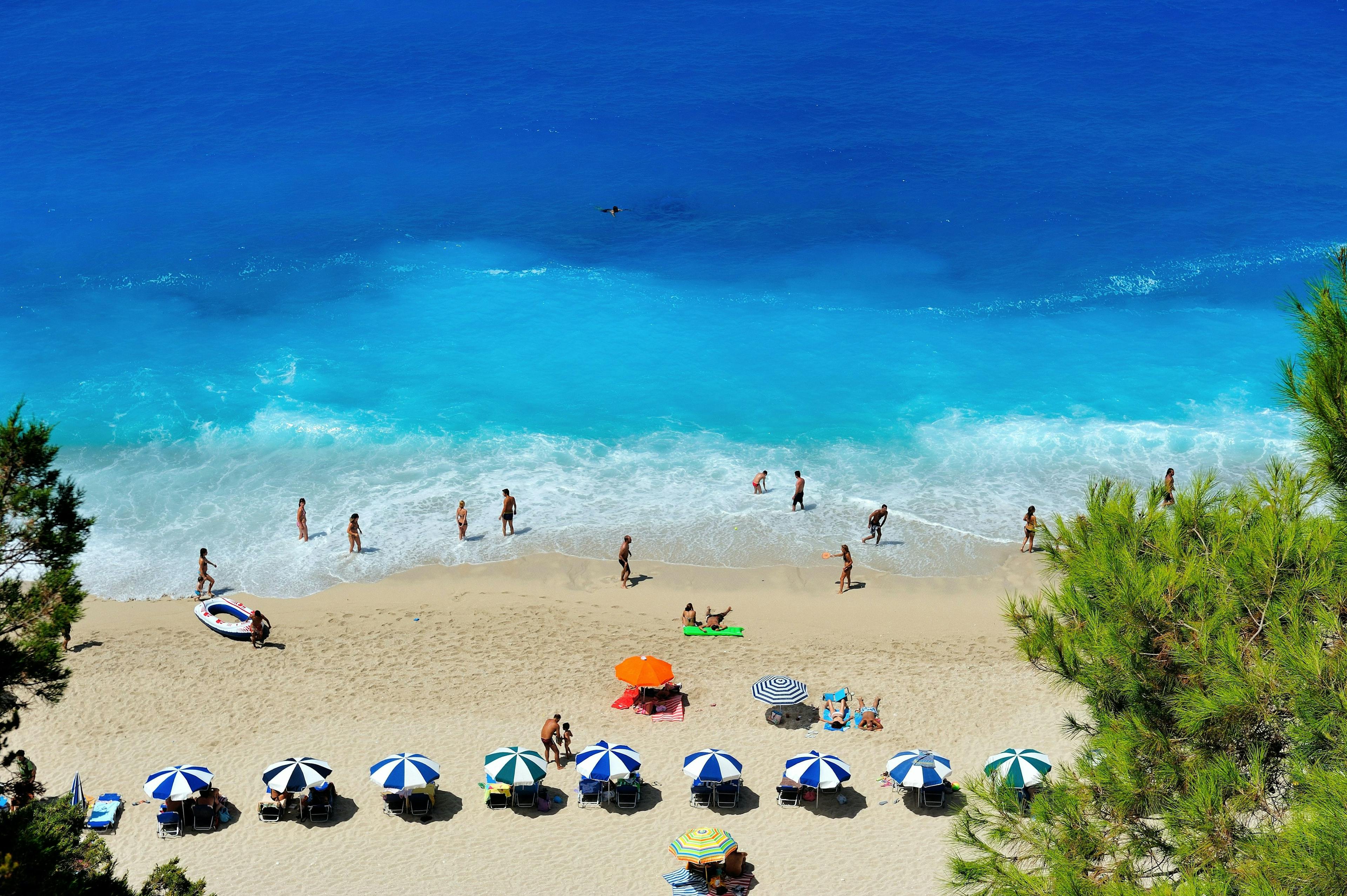 Umbrellas on a sunny beach in Mykonos Greece