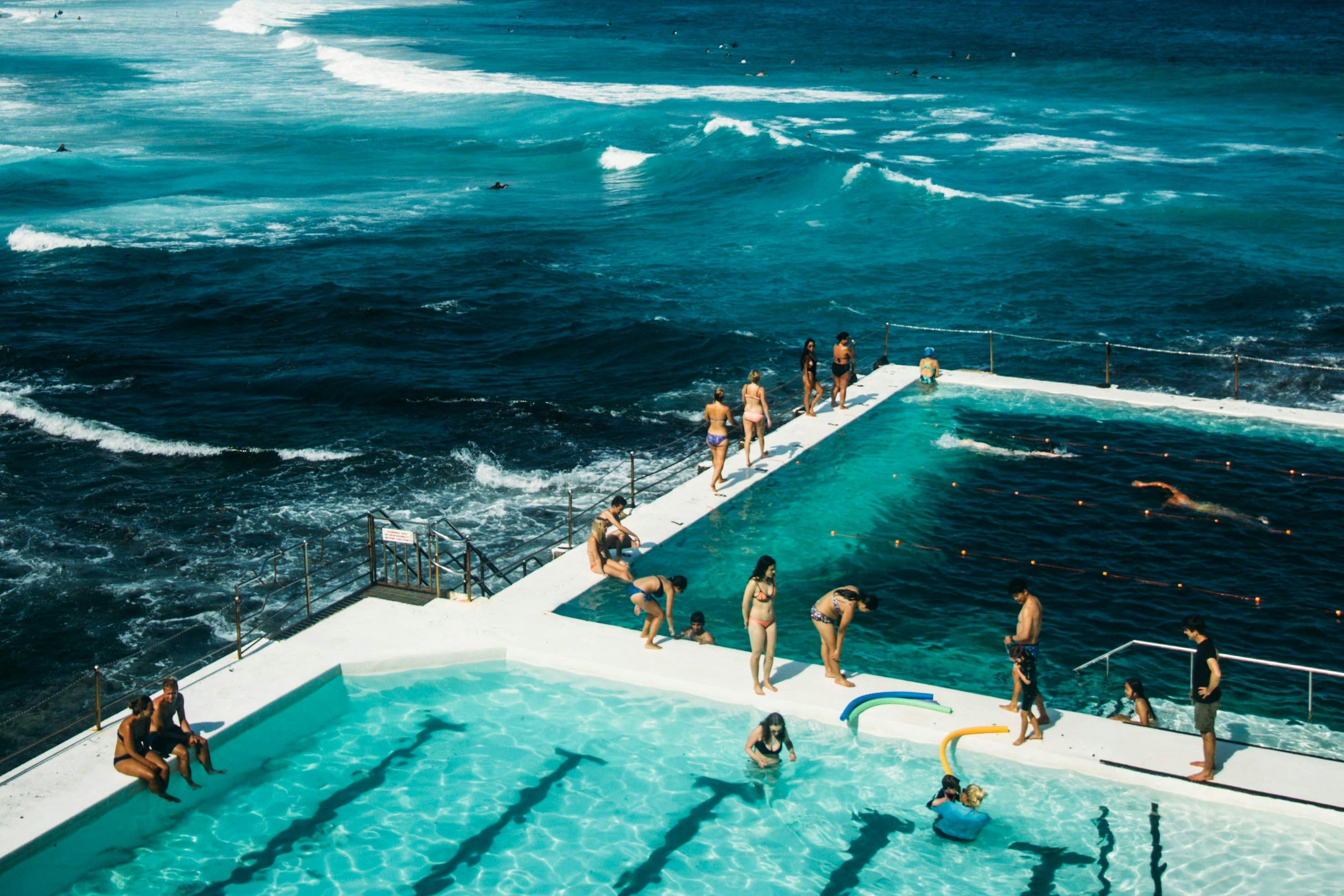 Swimming pool with people next to the ocean in Bondi Beach.