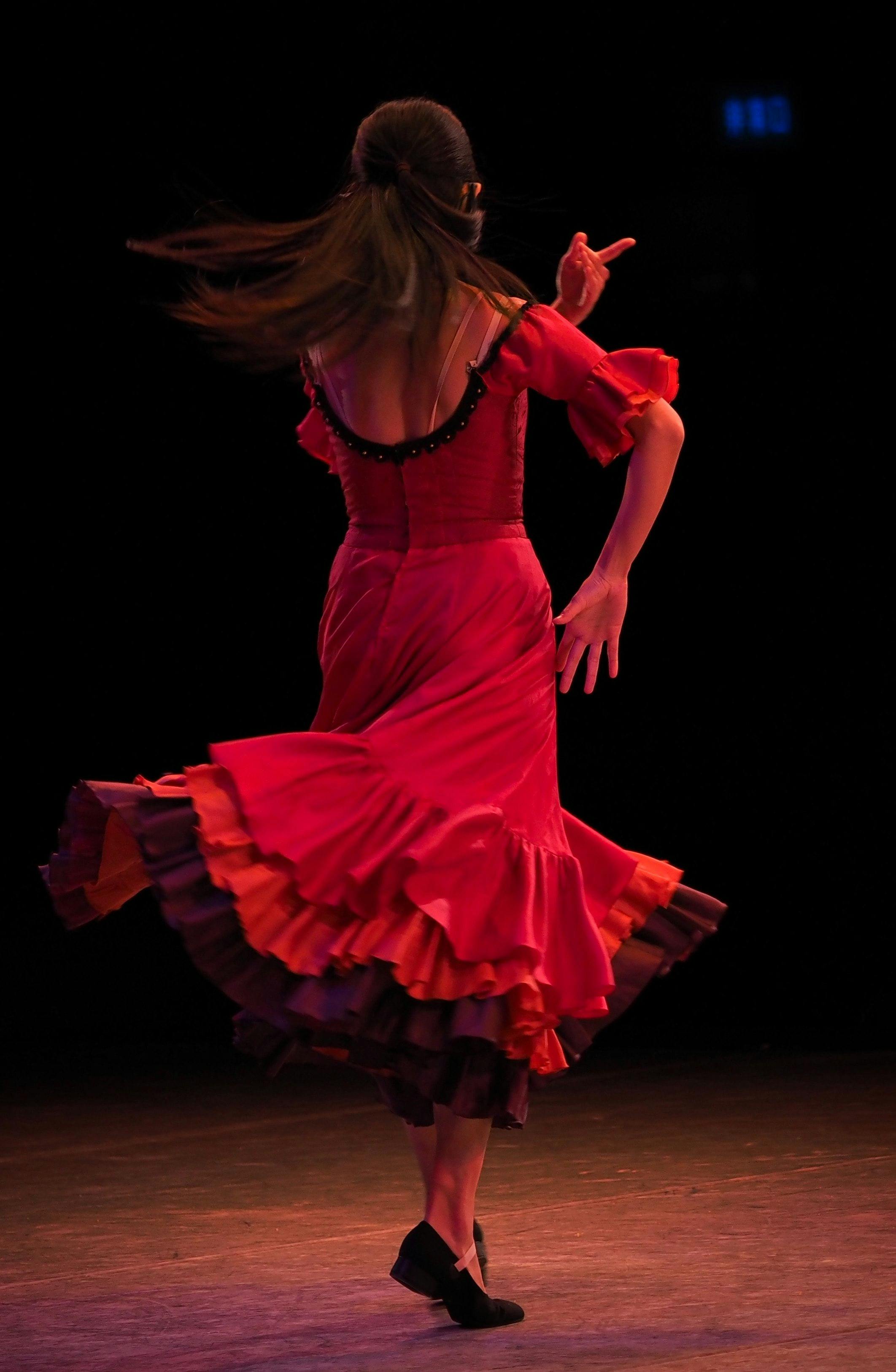 Woman wearing red dress dancing flamenco.