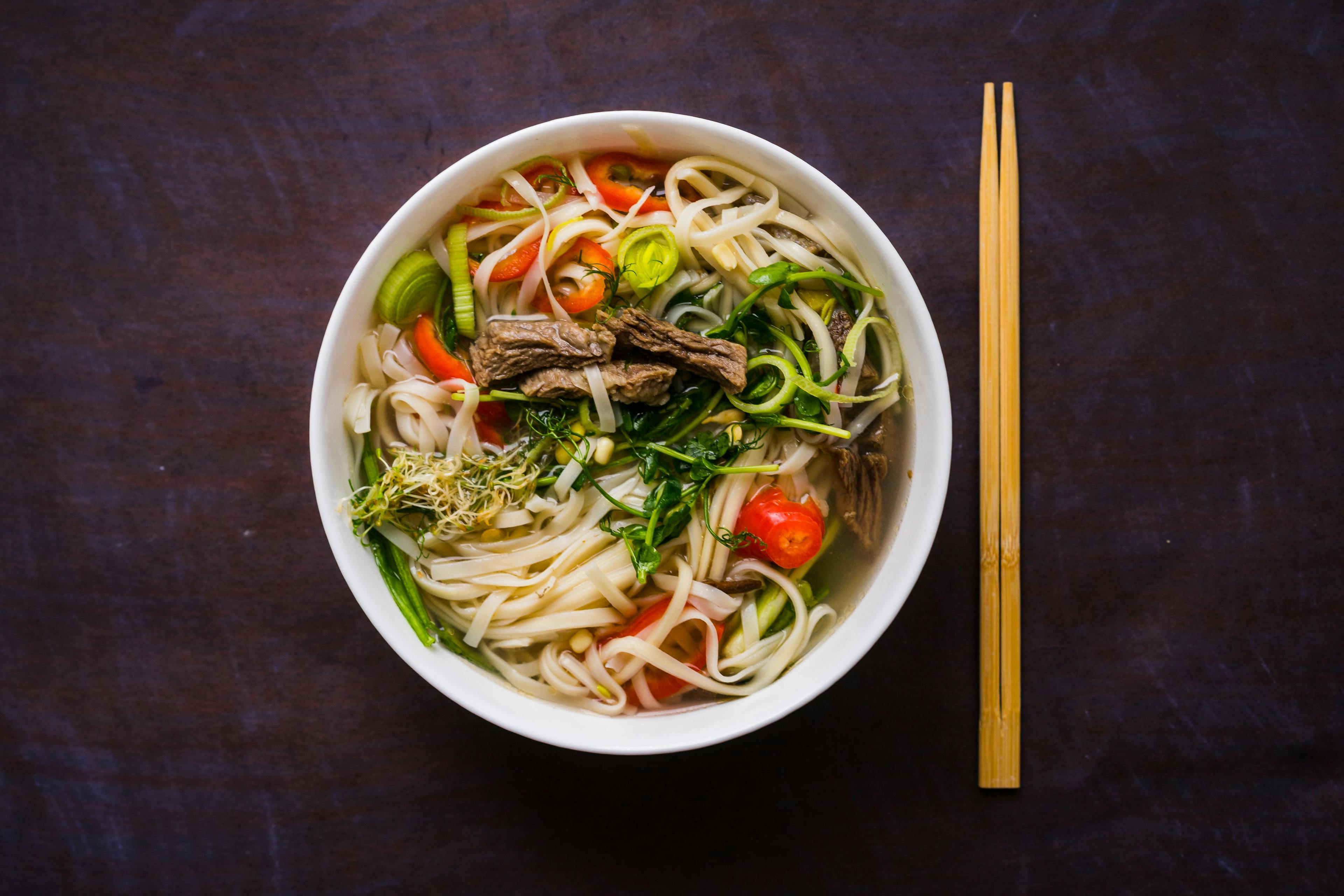 Pho Bo Vietnamese noodle soup in a bowl.