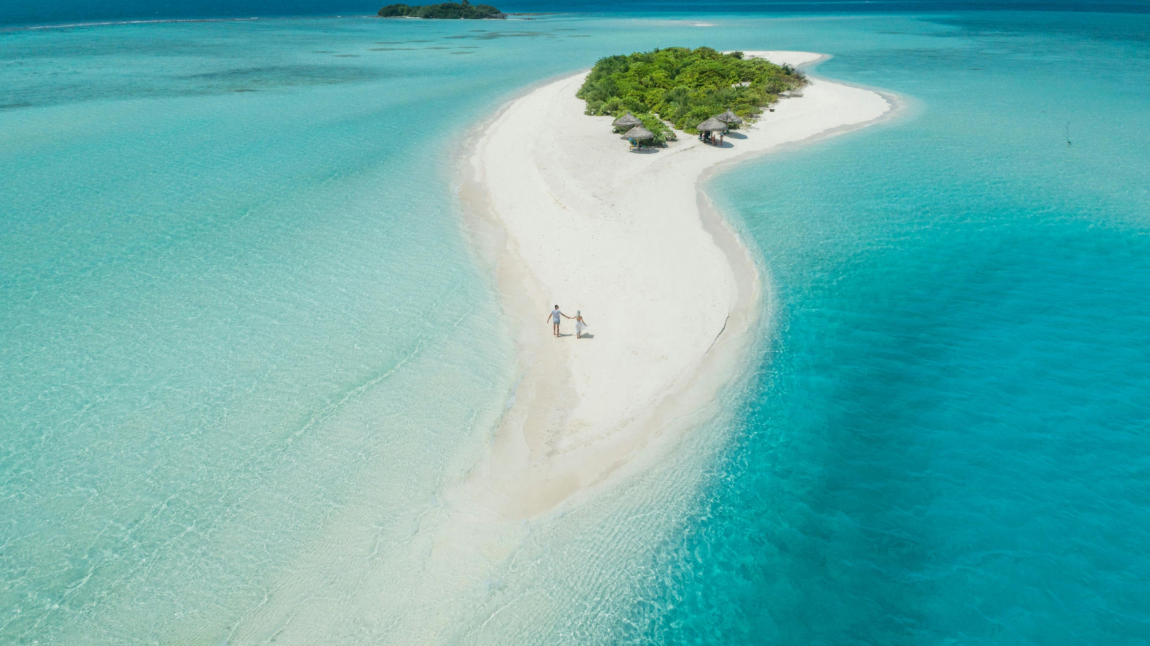 Couple walking on a deserted paradise island