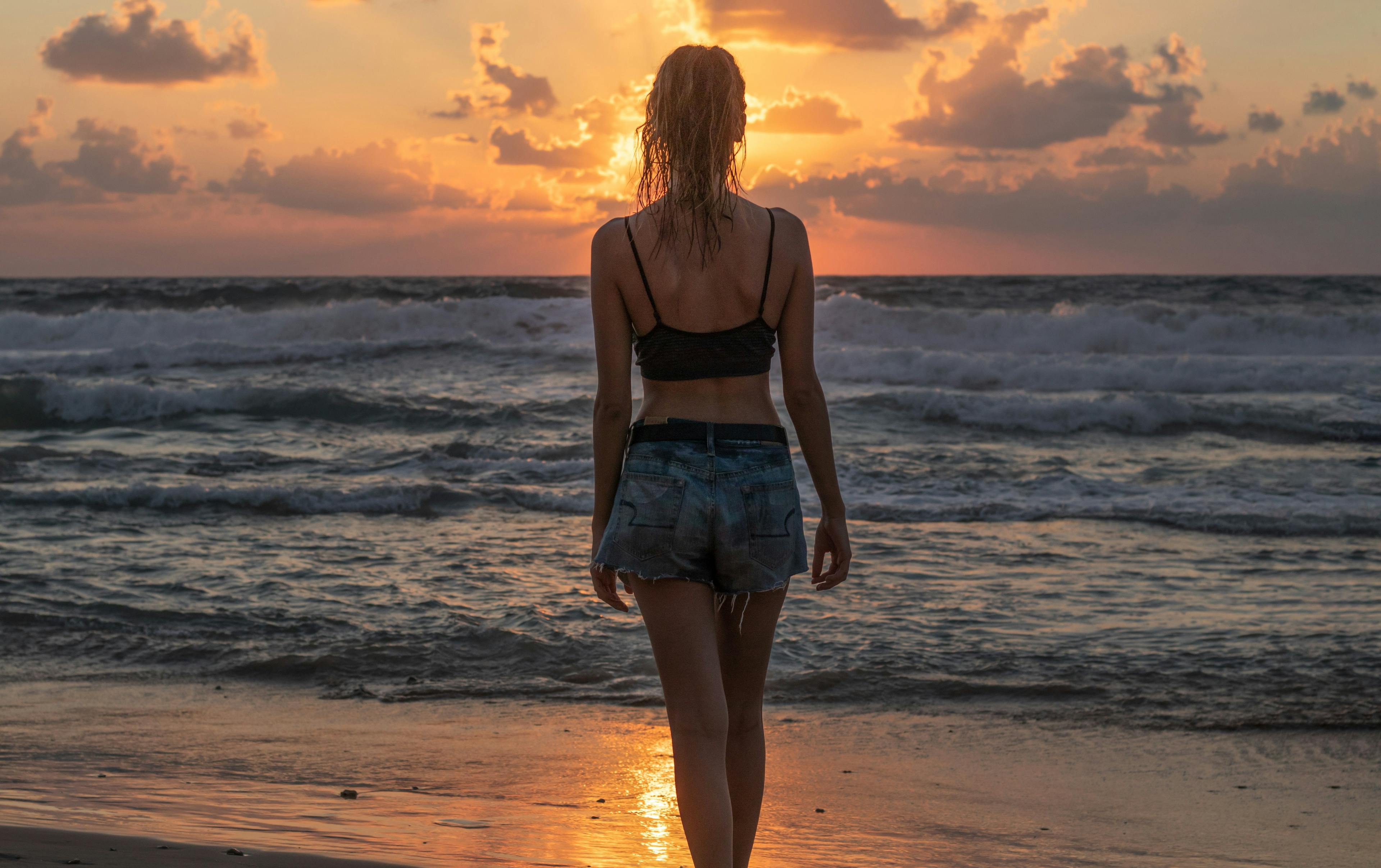 Woman watching sunset in Bali Island