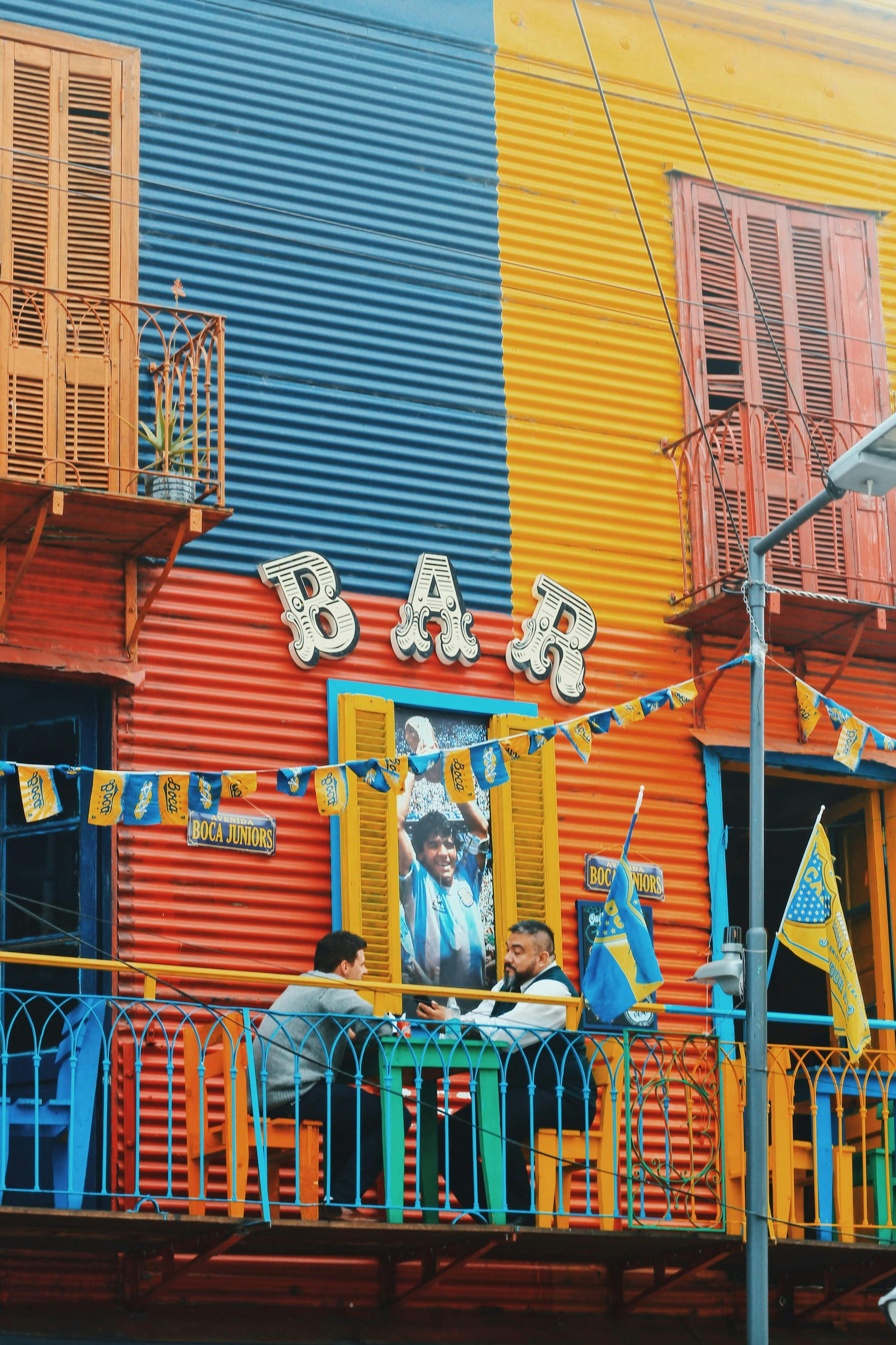 Men sitting in a colorful bar in Buenos Aires Argentina.