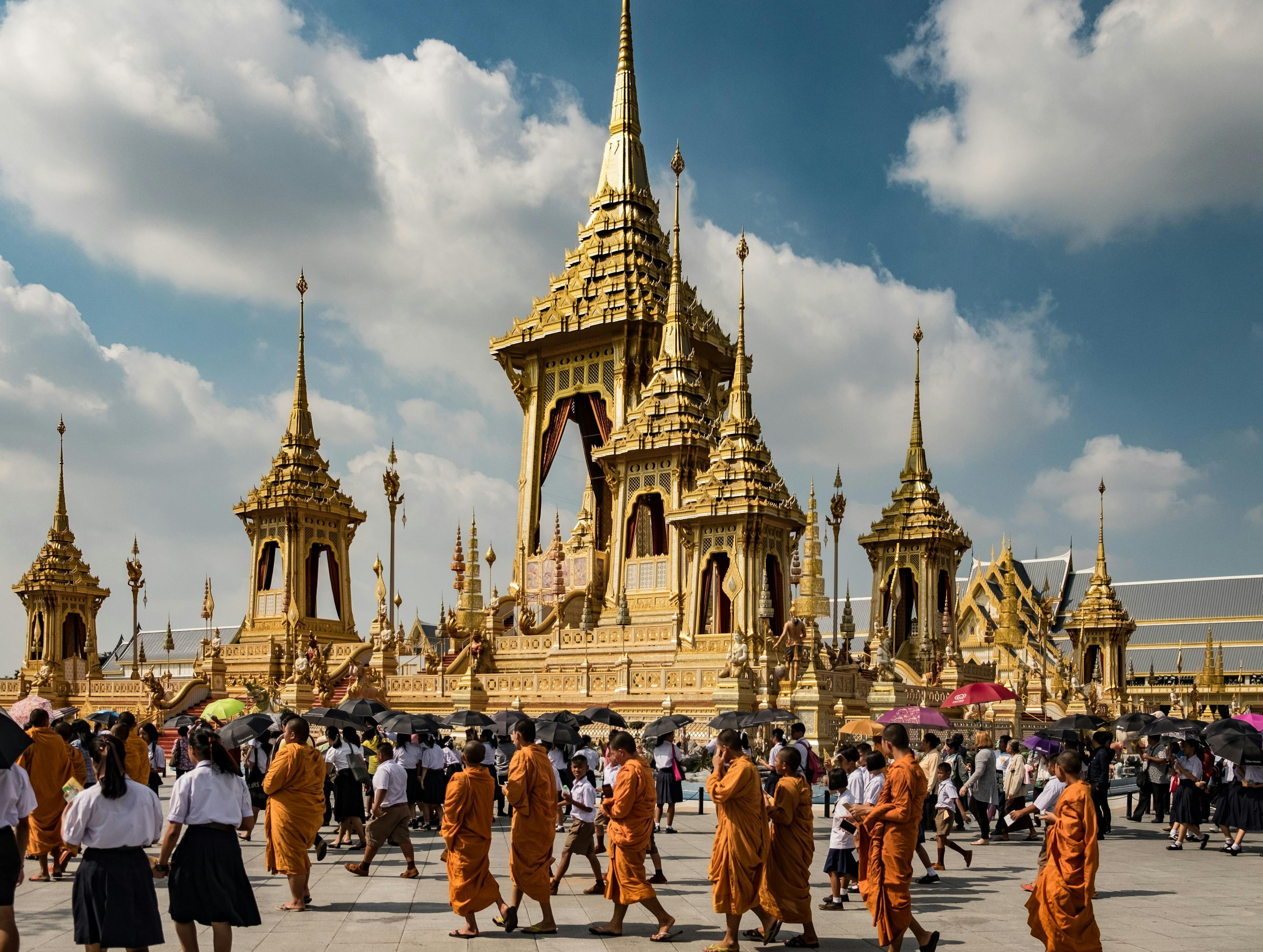 Buddhist monks walking in front of temple in Bangkok Thailand