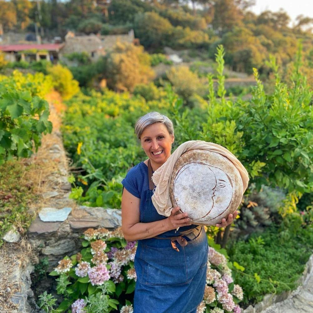 Happy woman with homemade bread in Ikaria Greece