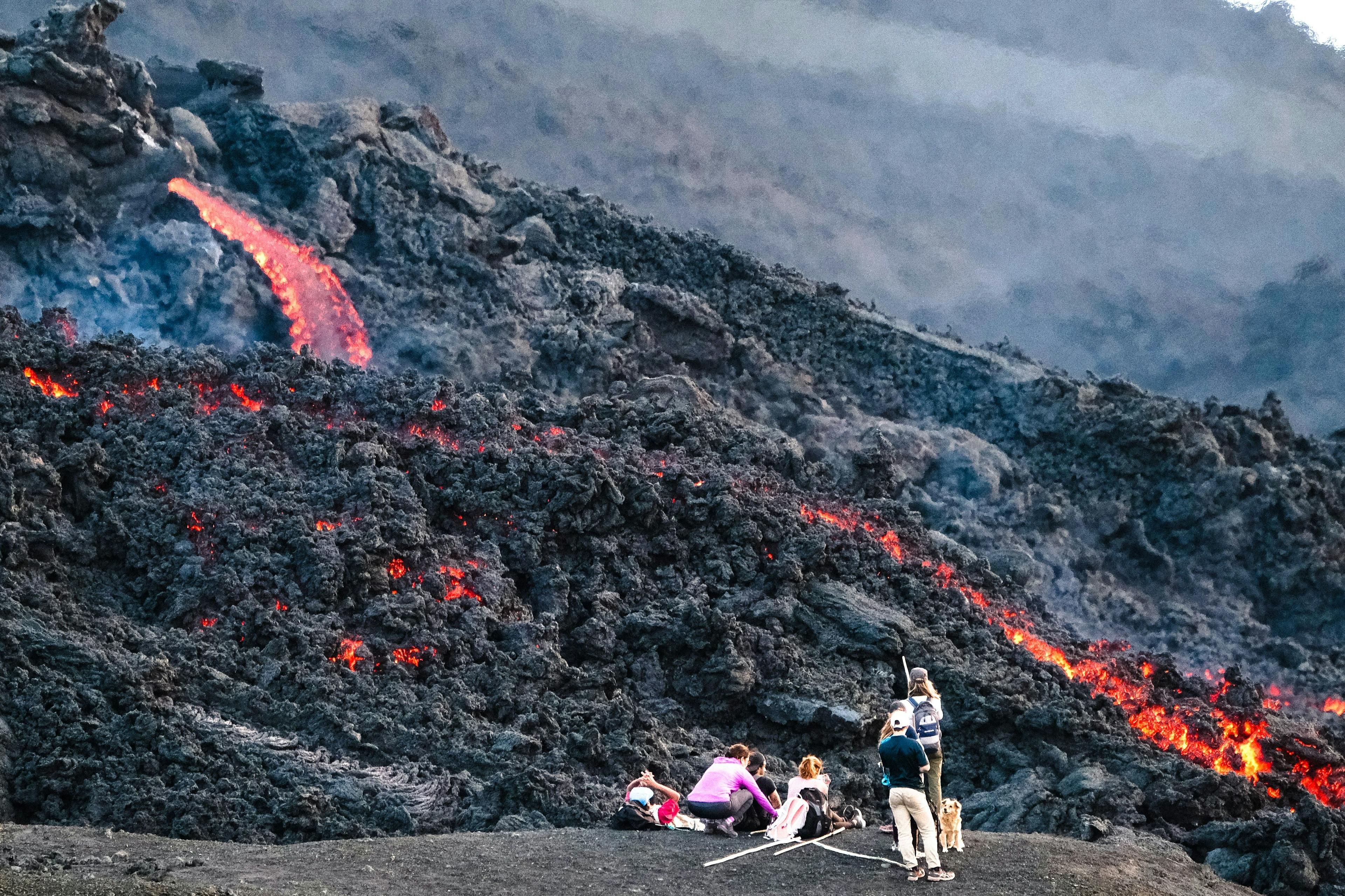 People watching lava on Pacaya volcano.
