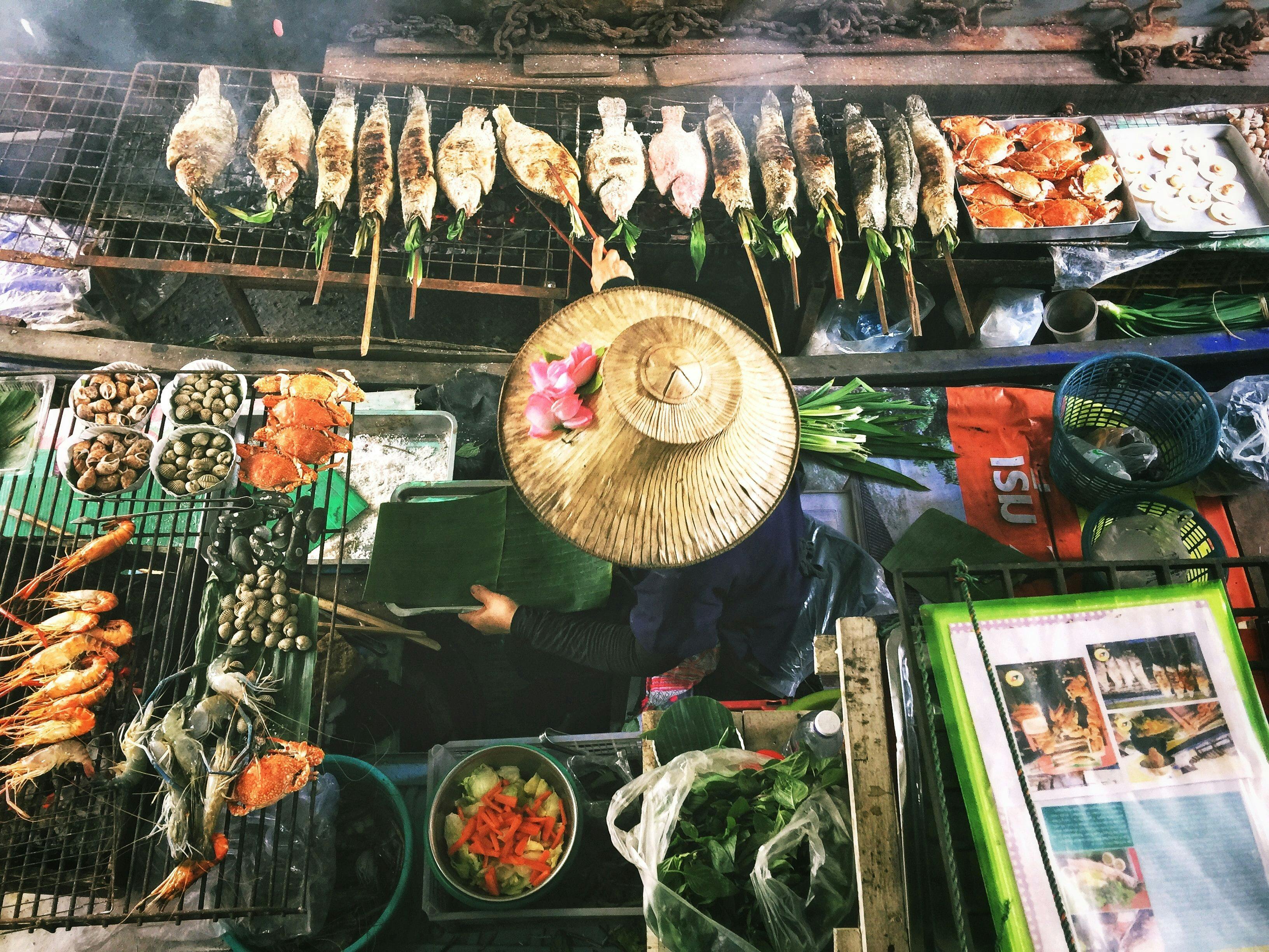 Woman cooking food in Thai food market in Bangkok