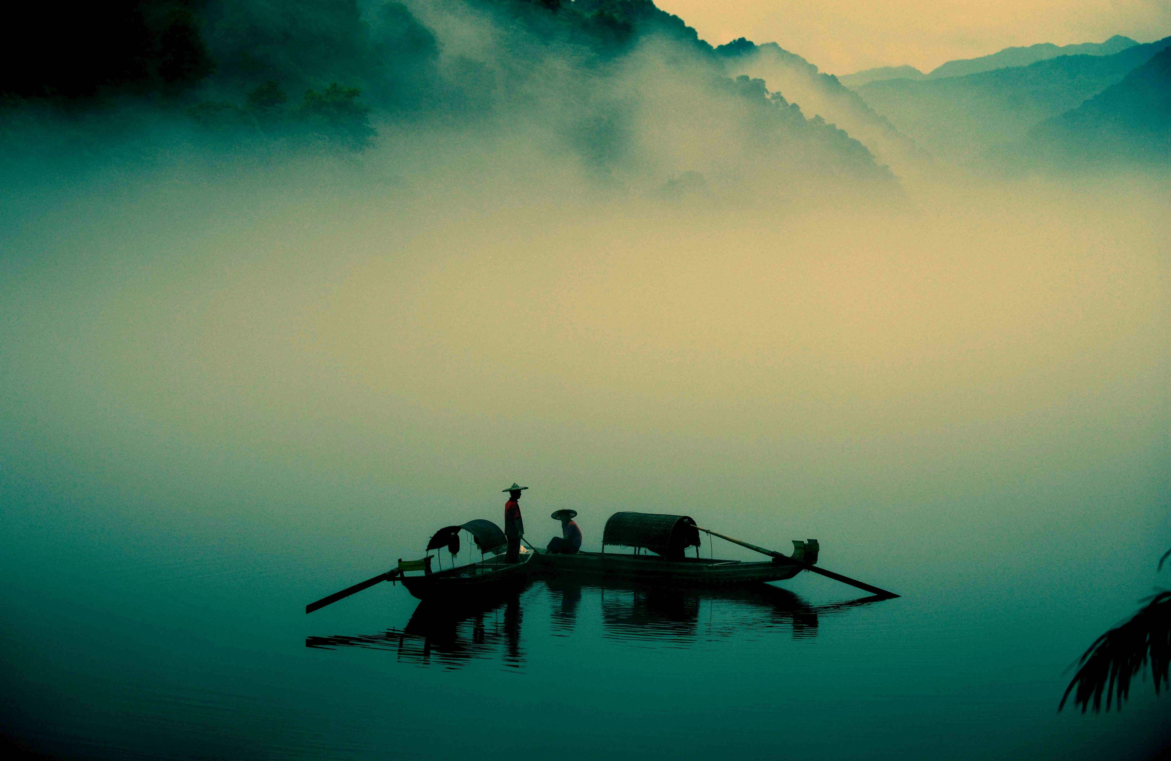 Men fishing on a misty lake in China