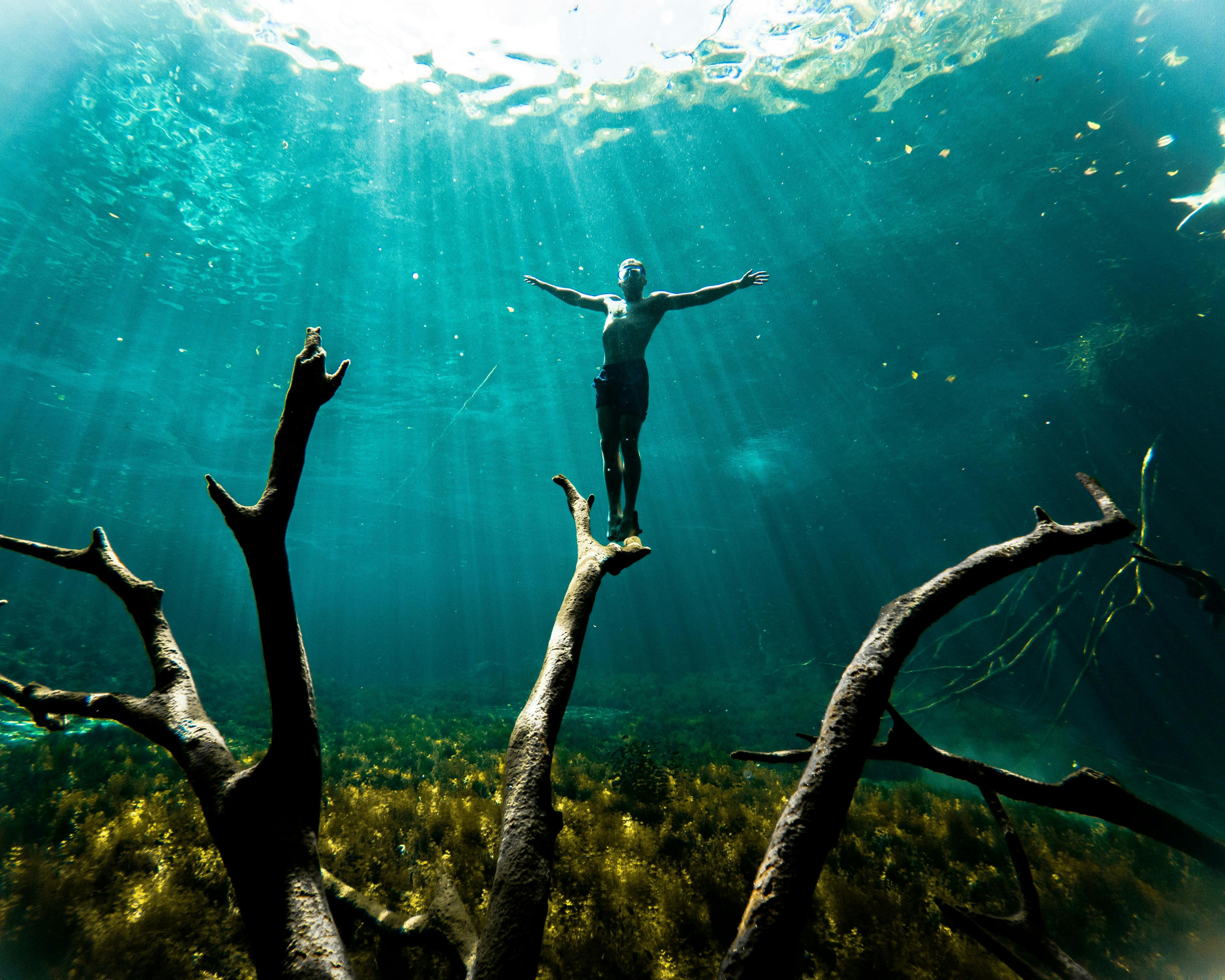 Woman standing under water in cenote in Tulum Mexico